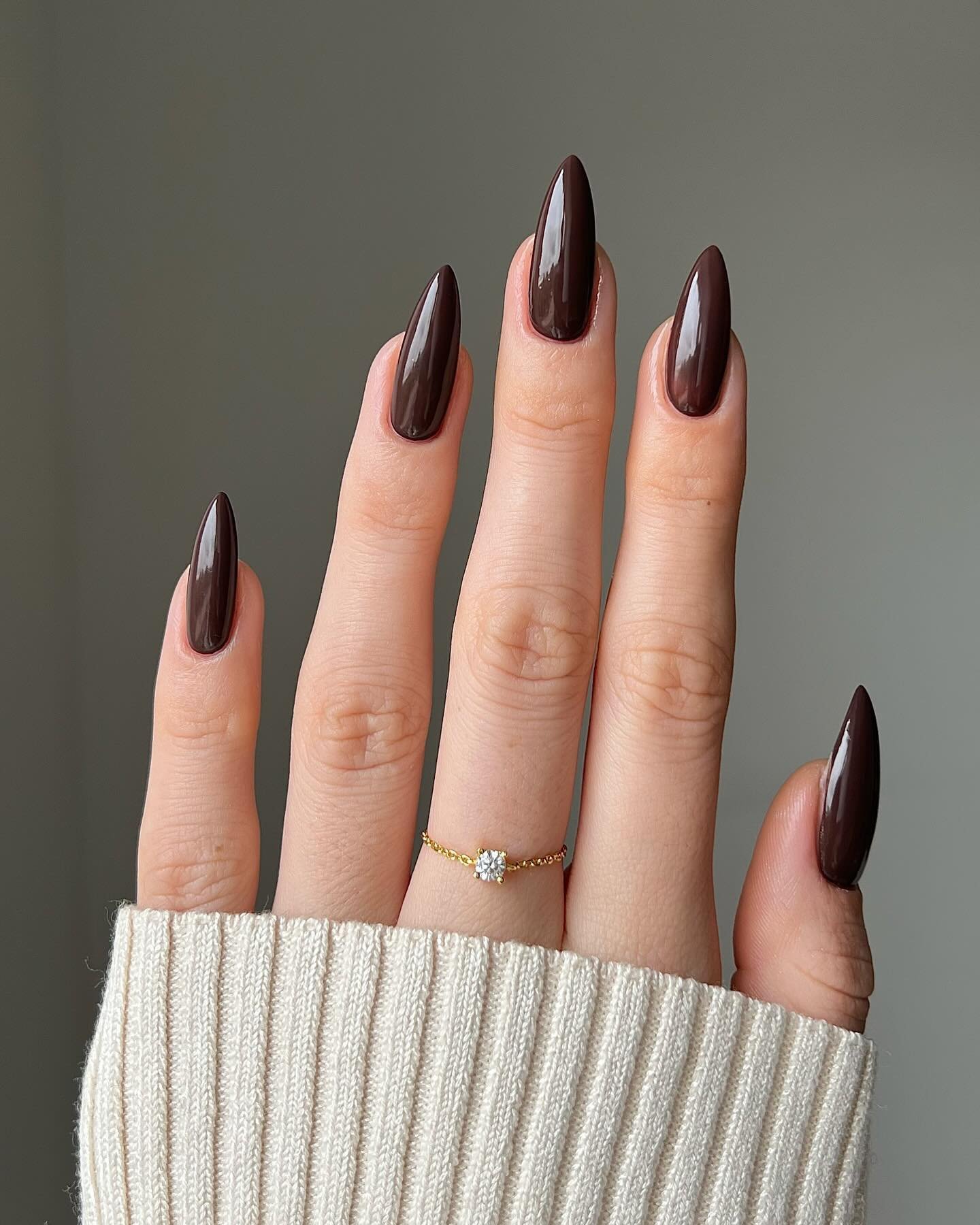 Dark Brown Almond Nails with Sparkling Accent