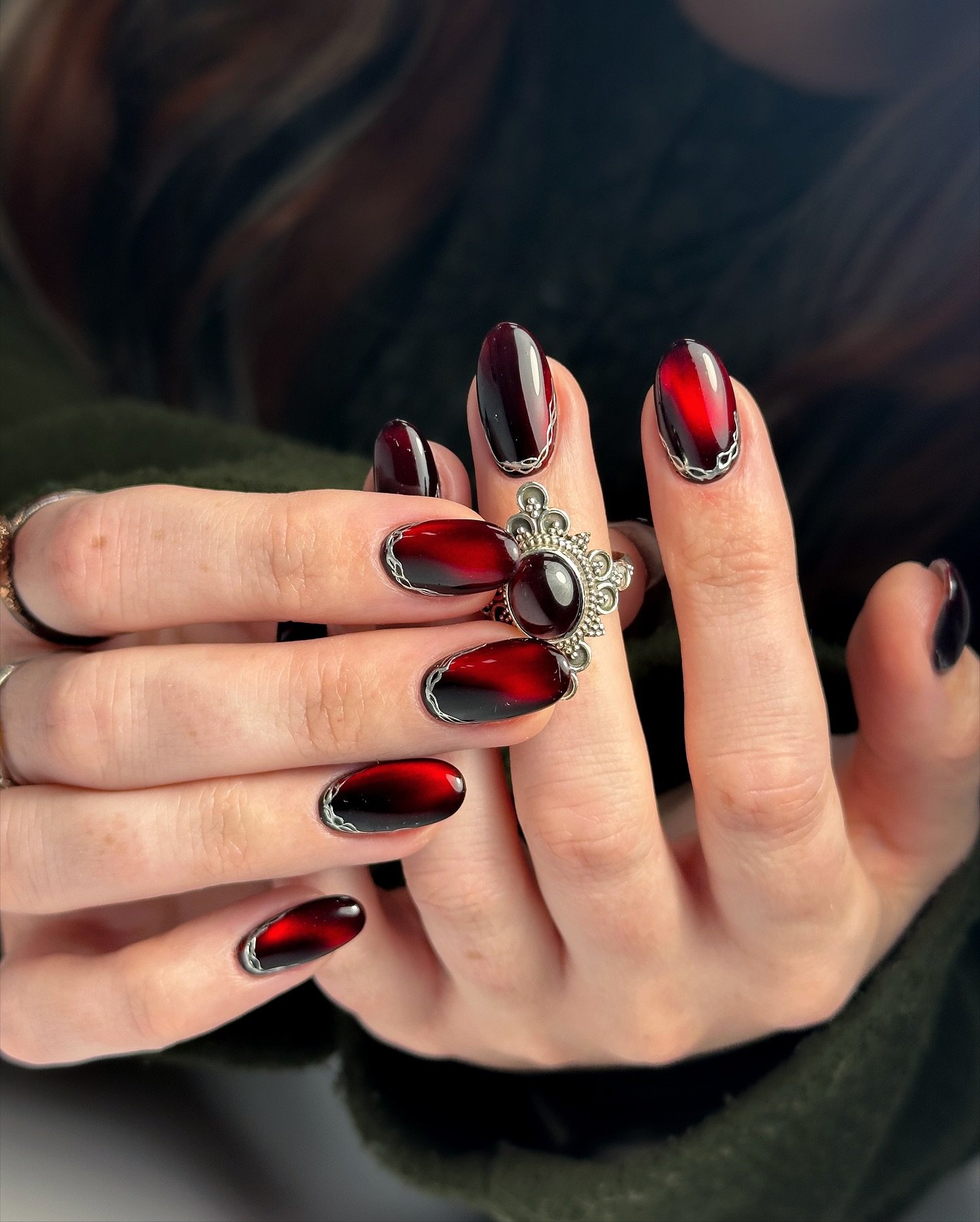 Black and Red Glossy Almond Nails with Metallic Accent