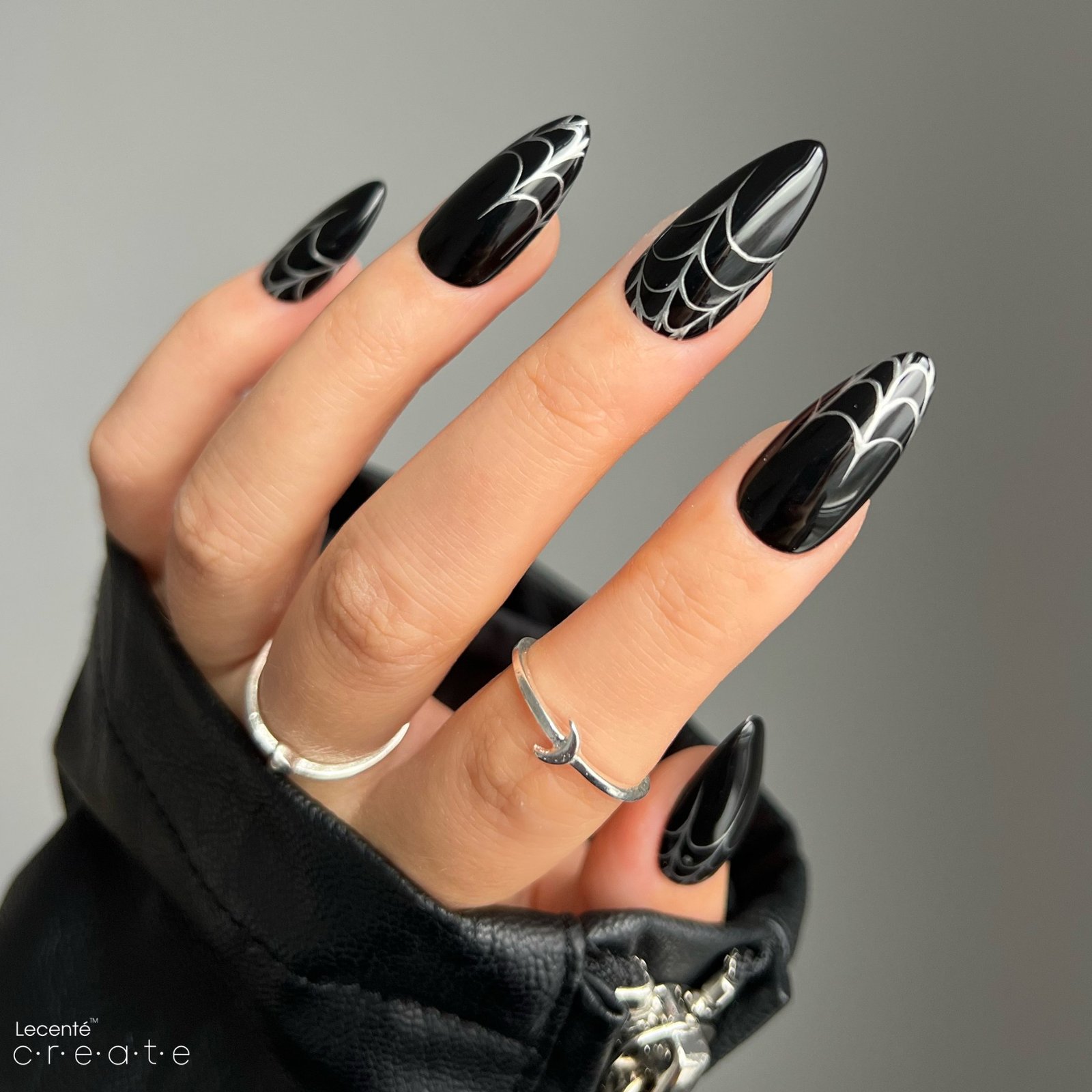 Glossy Black Almond Nails with White Spiderwebs