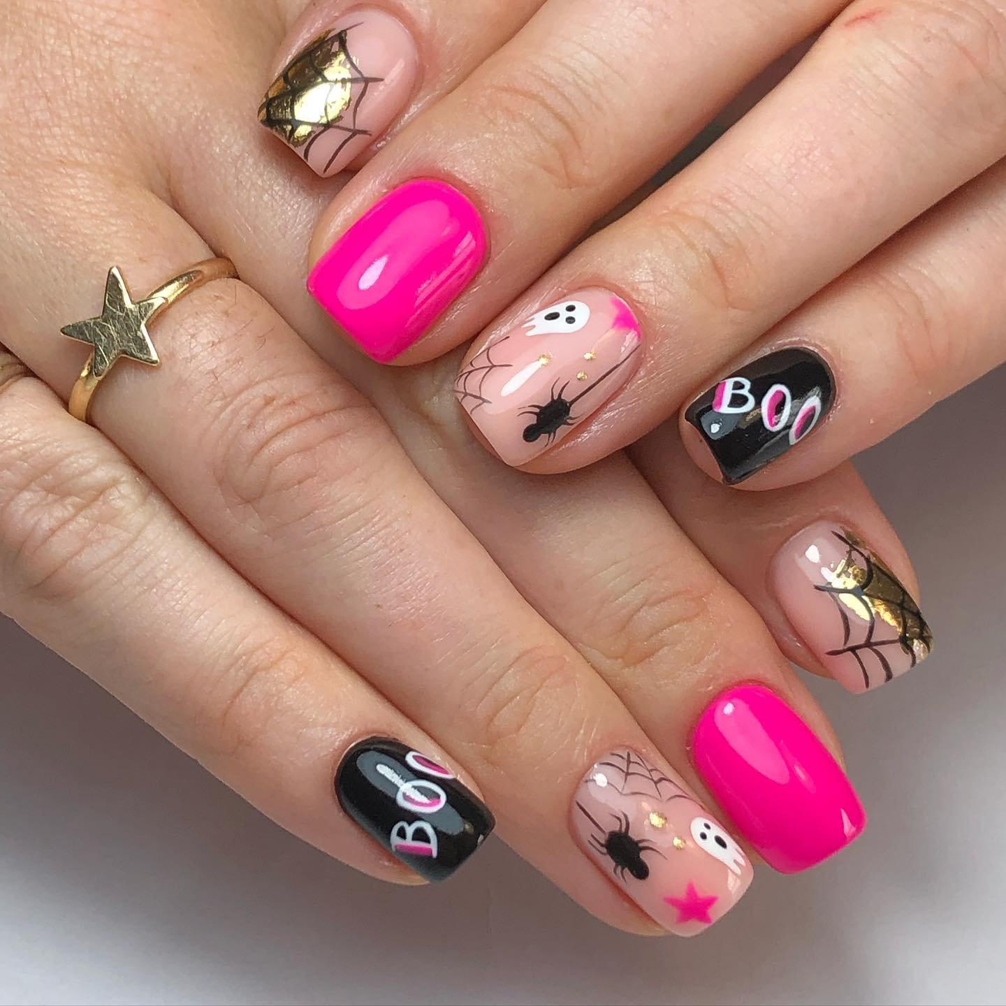 Bright Pink Halloween Nails with Bats and Spiderweb Details