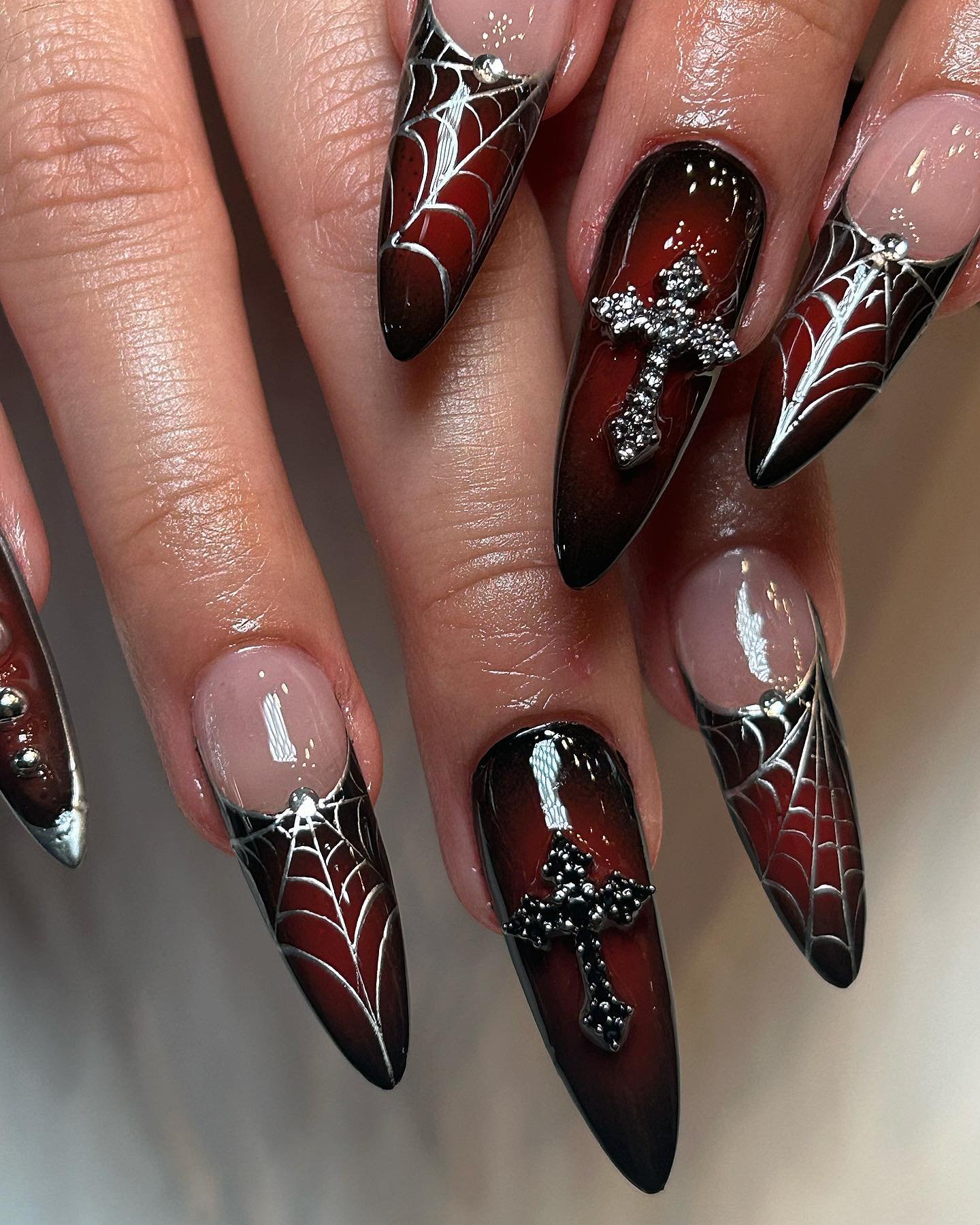 Deep Red and Black Stiletto Nails with Spiderwebs and Rhinestones