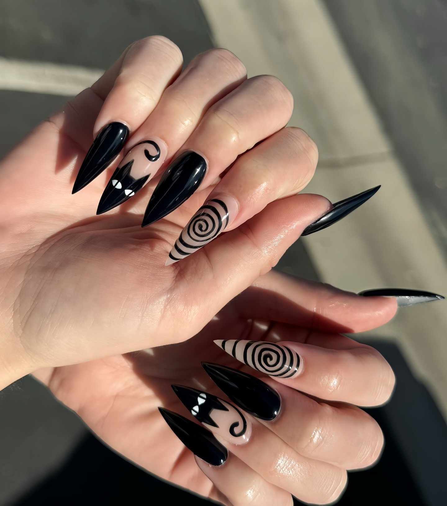 Black Stiletto Nails with White Swirls and Spiral Accents