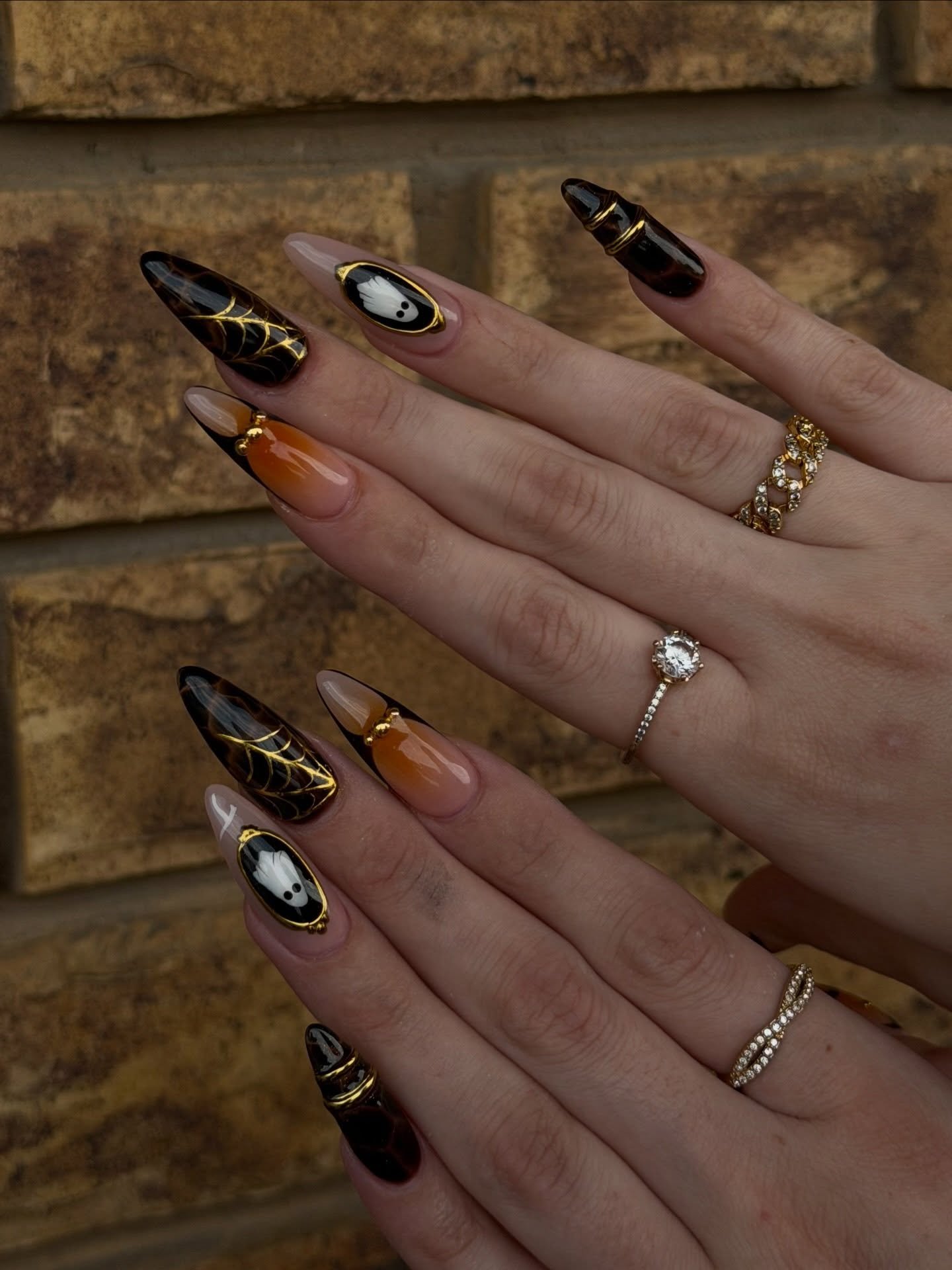 Black and Nude Stiletto Nails with Gold and White Halloween Accents