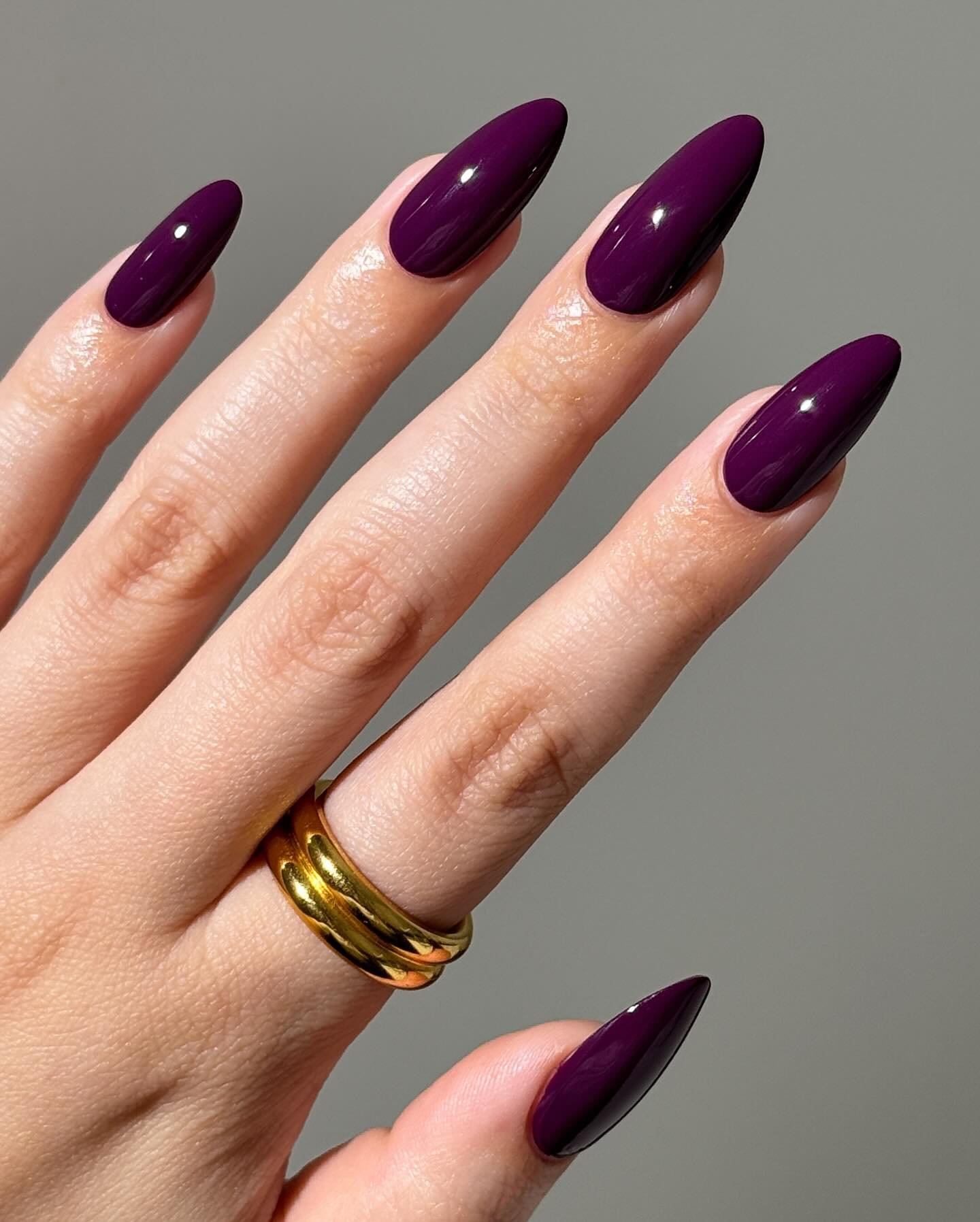 Glossy Deep Purple Almond Nails