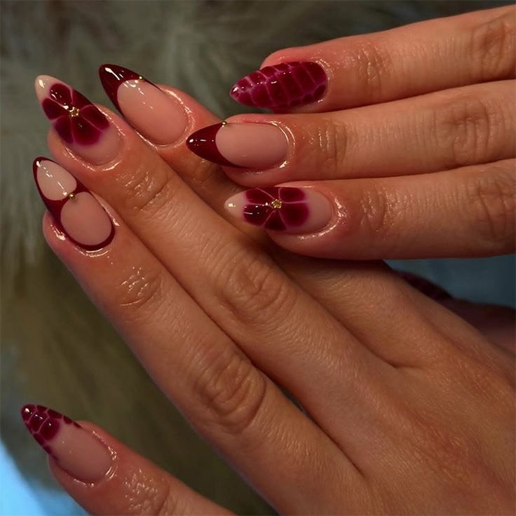 Deep red almond nails with nude accents