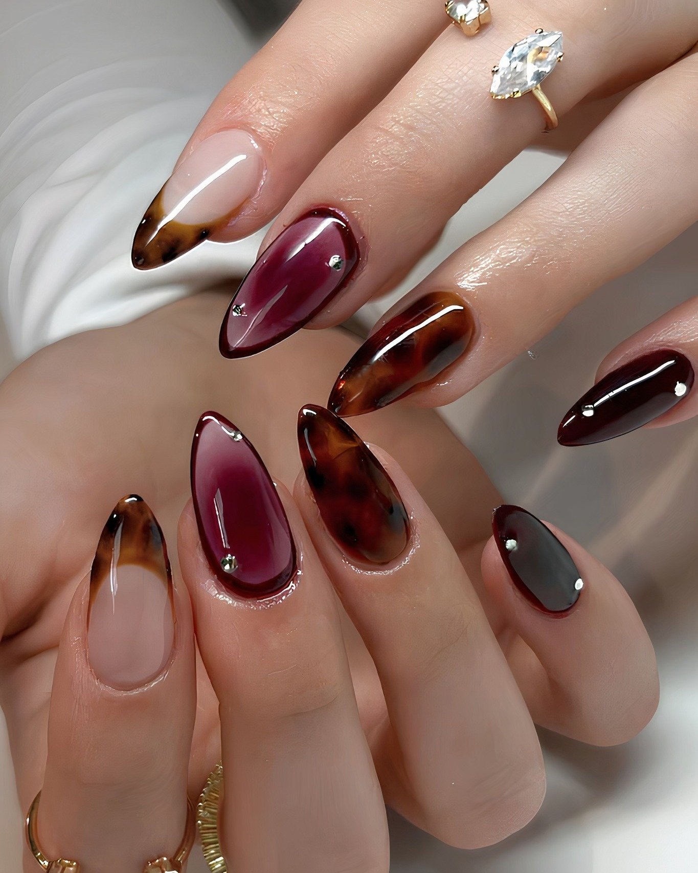 Mixed burgundy brown and nude almond nails
