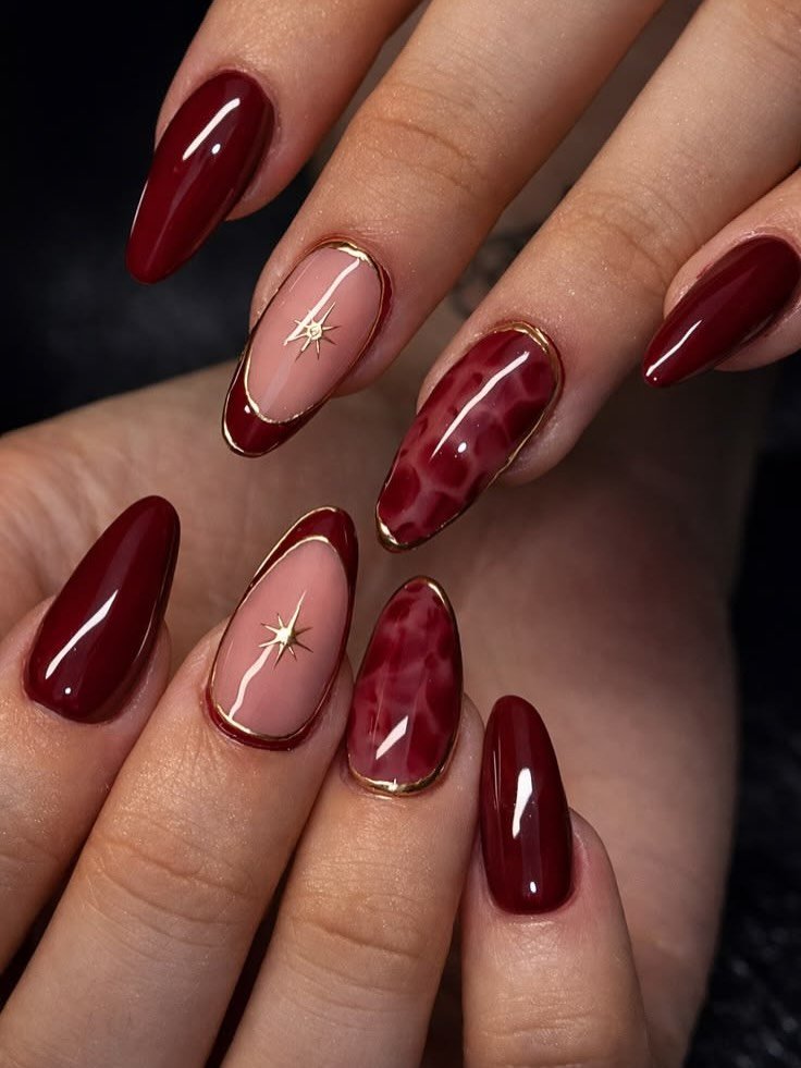 Glossy burgundy almond nails with nude accents