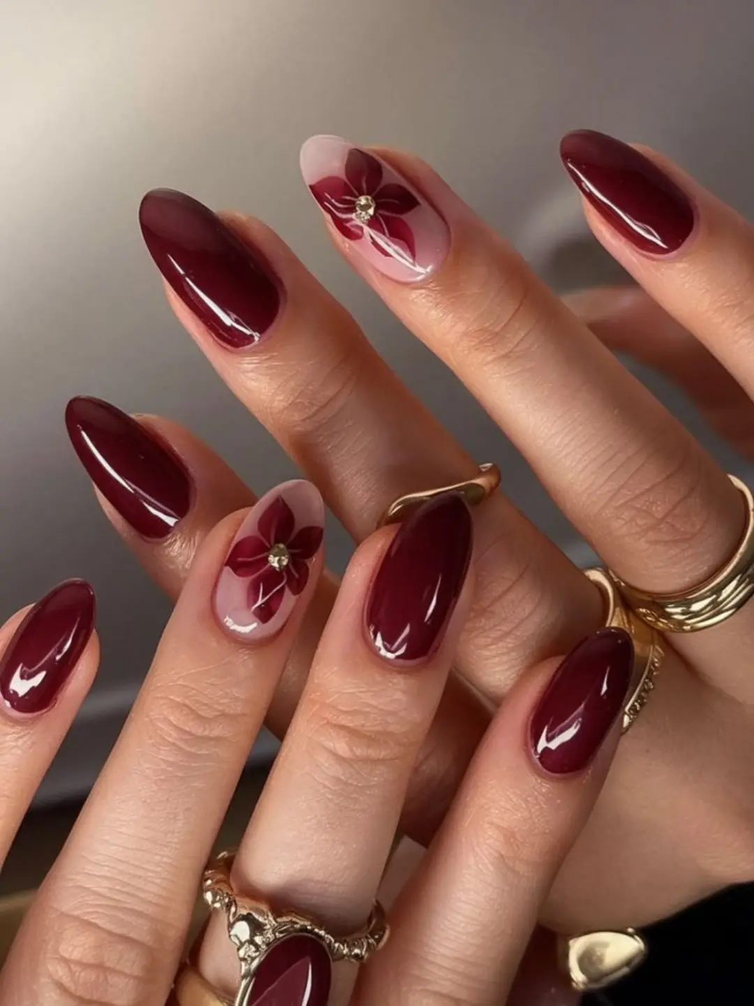Burgundy almond nails with pink floral accents