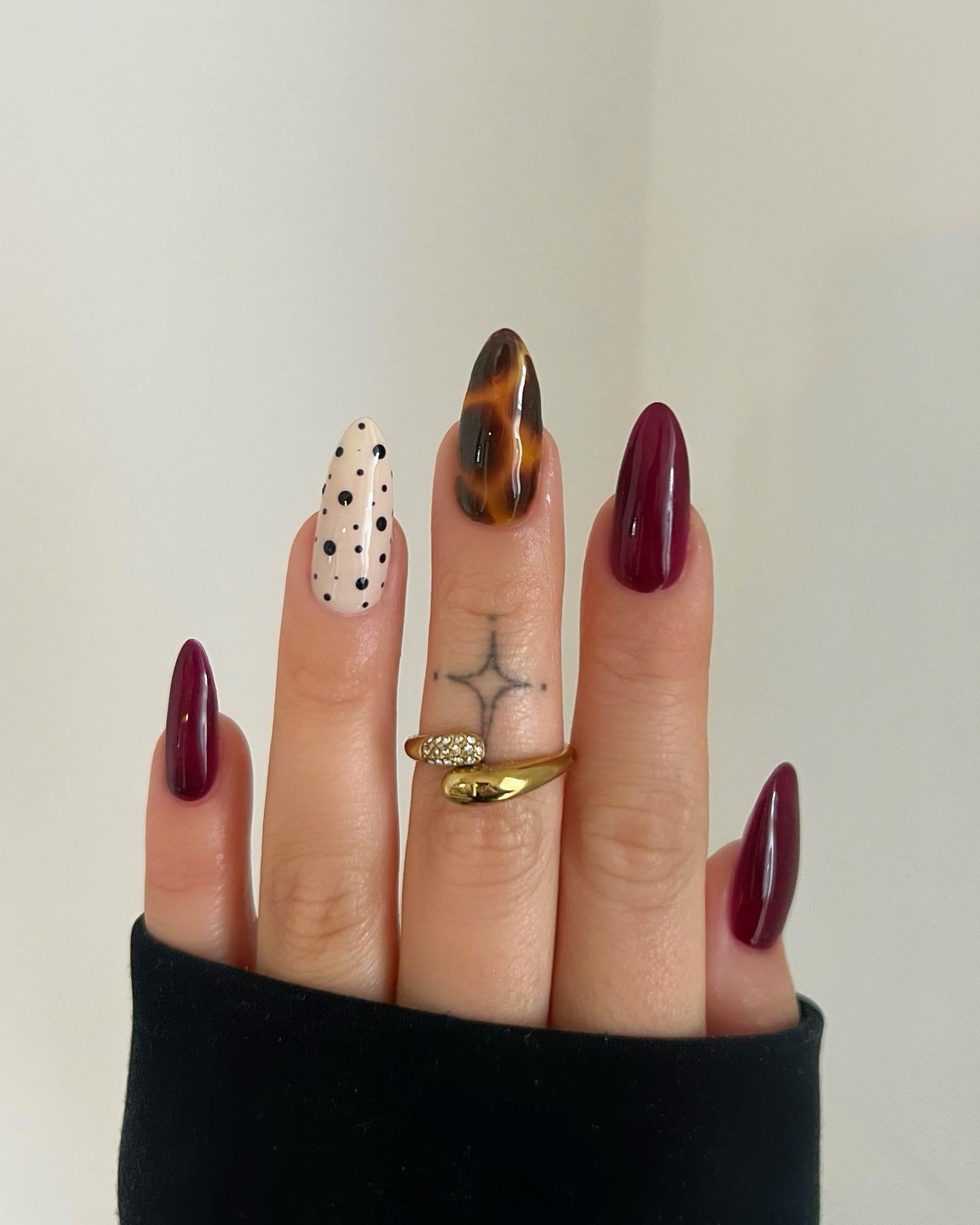 Mixed burgundy nails with leopard and marbled accents