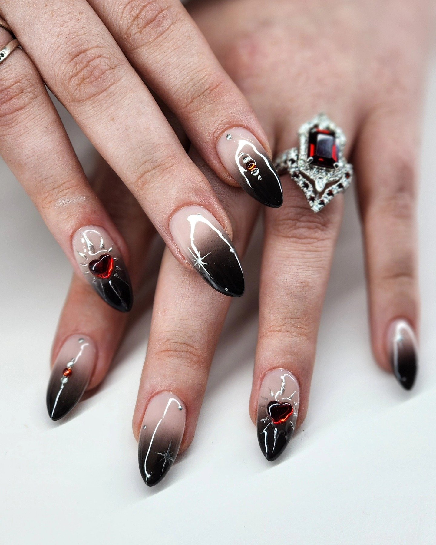 Black-Tipped Almond Nails with Red Accents