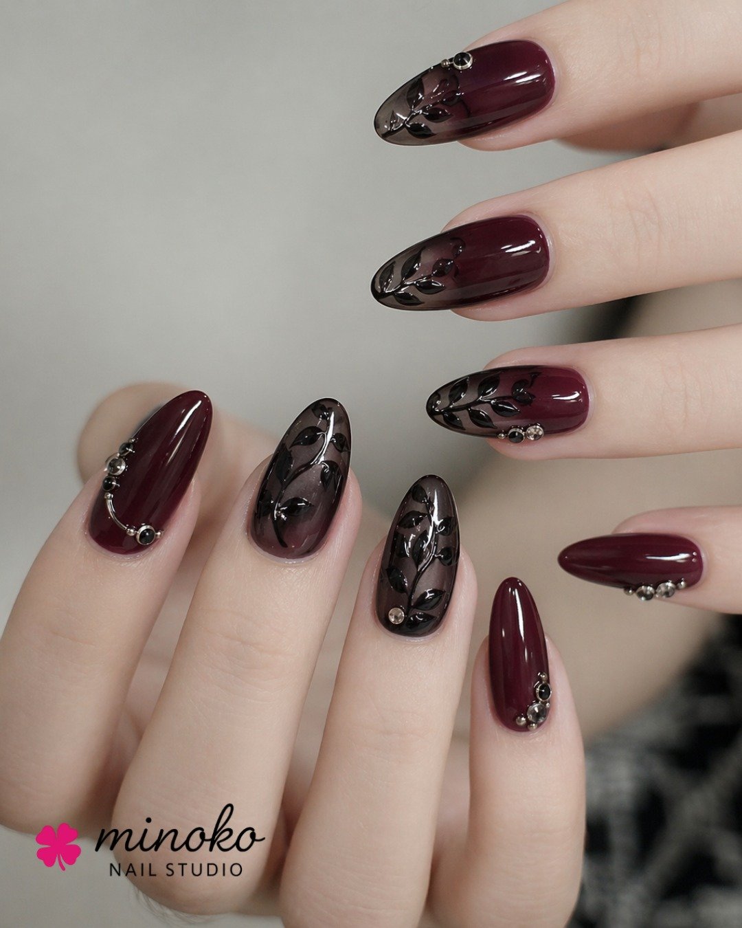 Glossy Burgundy Almond Nails with Dark Accents