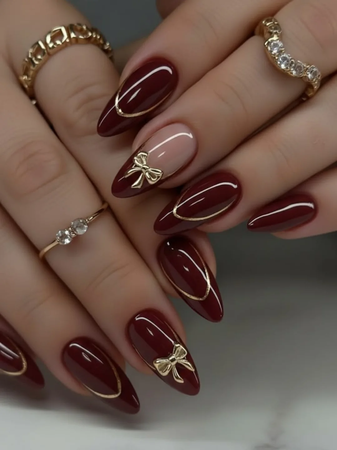 Deep Burgundy Almond Nails with Gold Accents