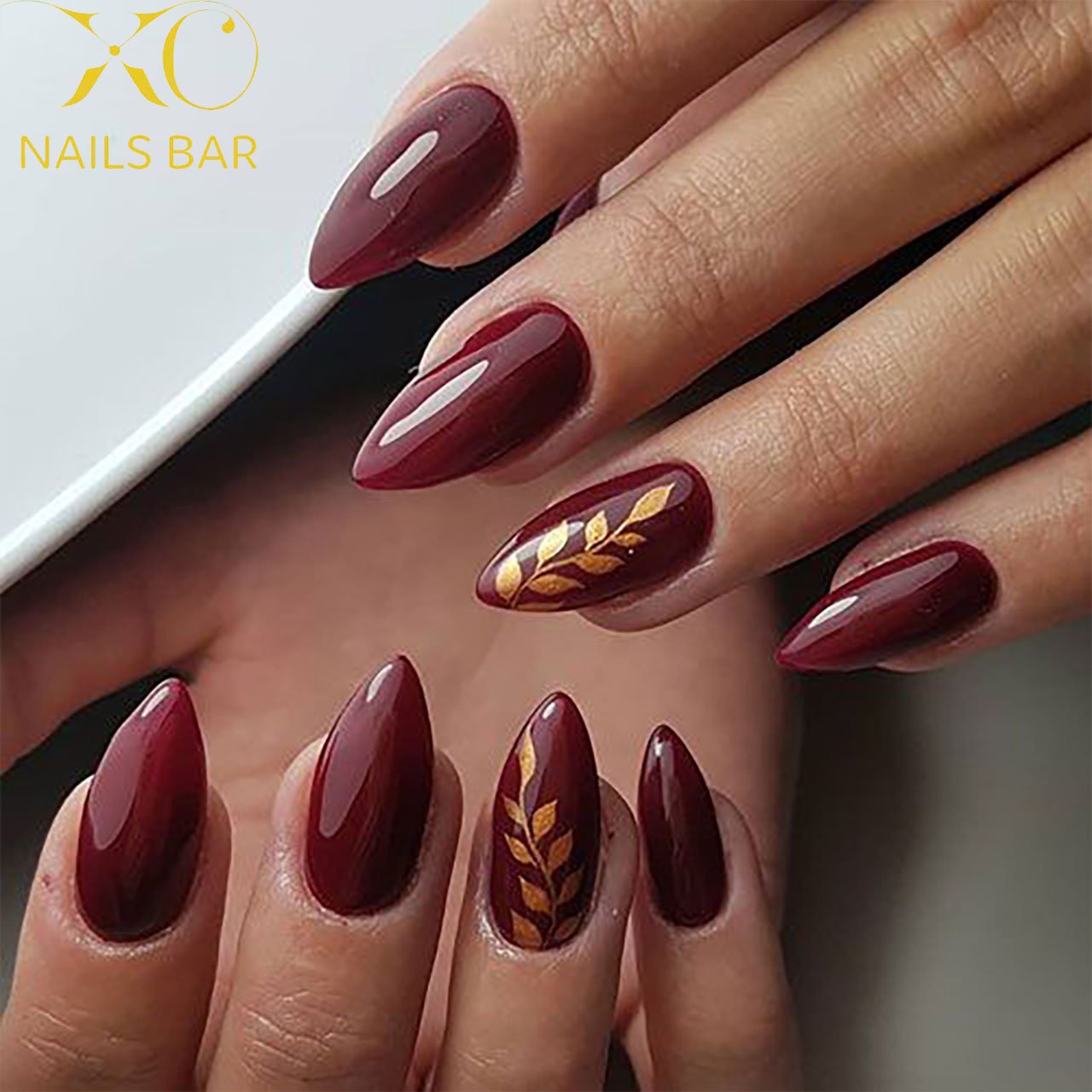 Burgundy Almond Nails with Gold Leaf Detail