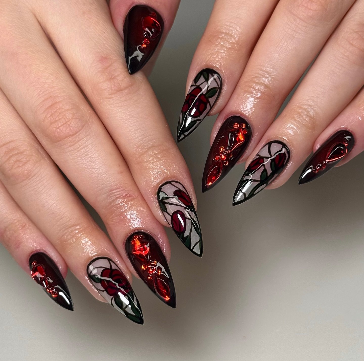 Black and Red Almond Nails with Ornamental Details