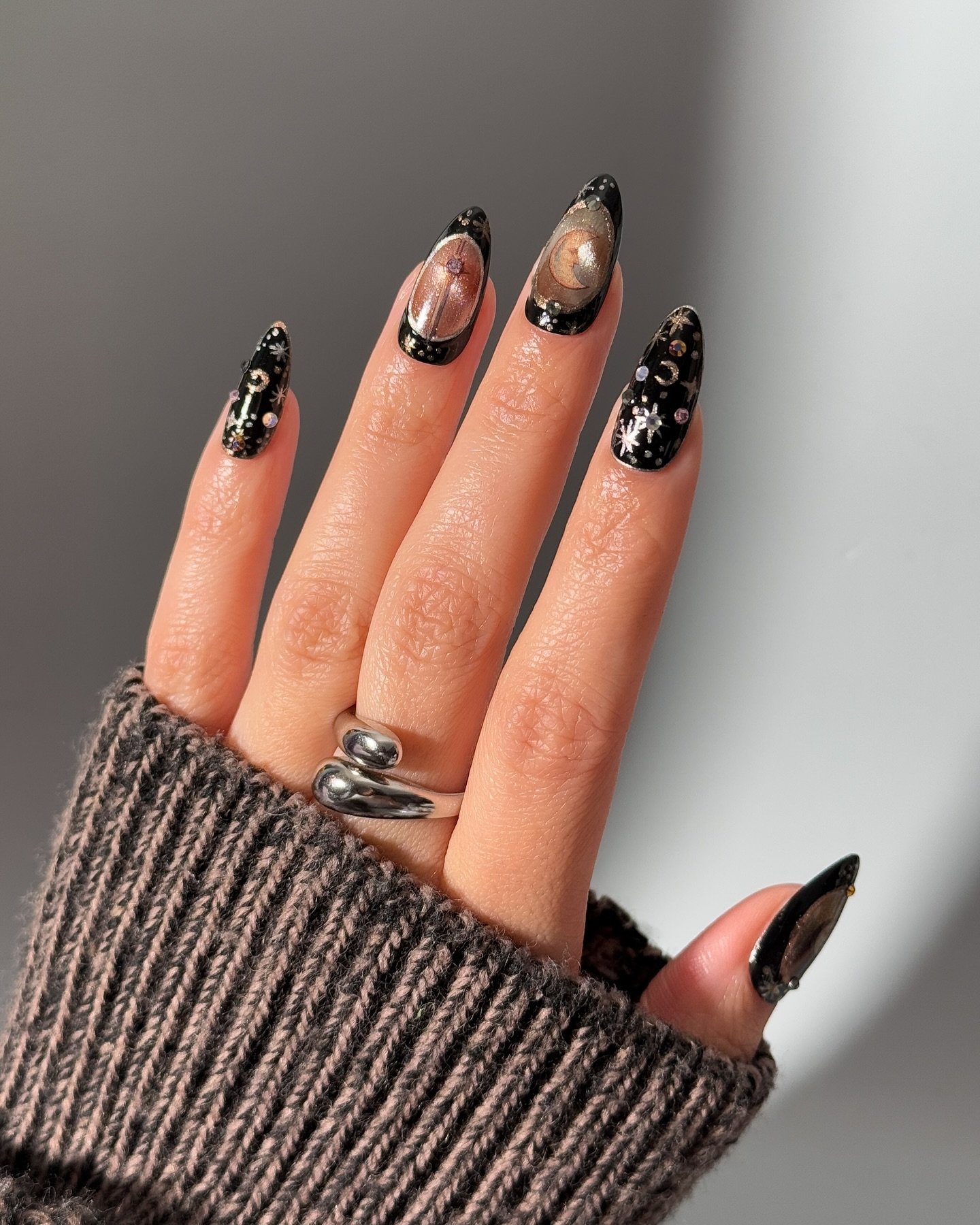 Black and Nude Almond Nails with Metallic Details