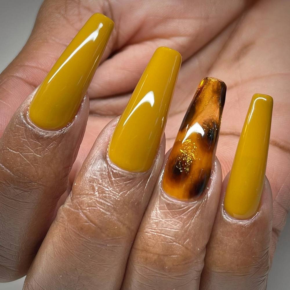 Mustard Yellow Nails with a Brown Marbled Accent