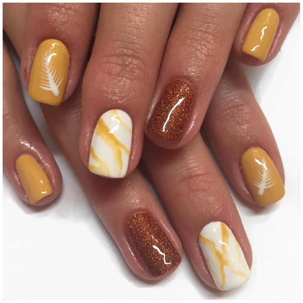 Brown and Yellow Nails with White Marble Accents