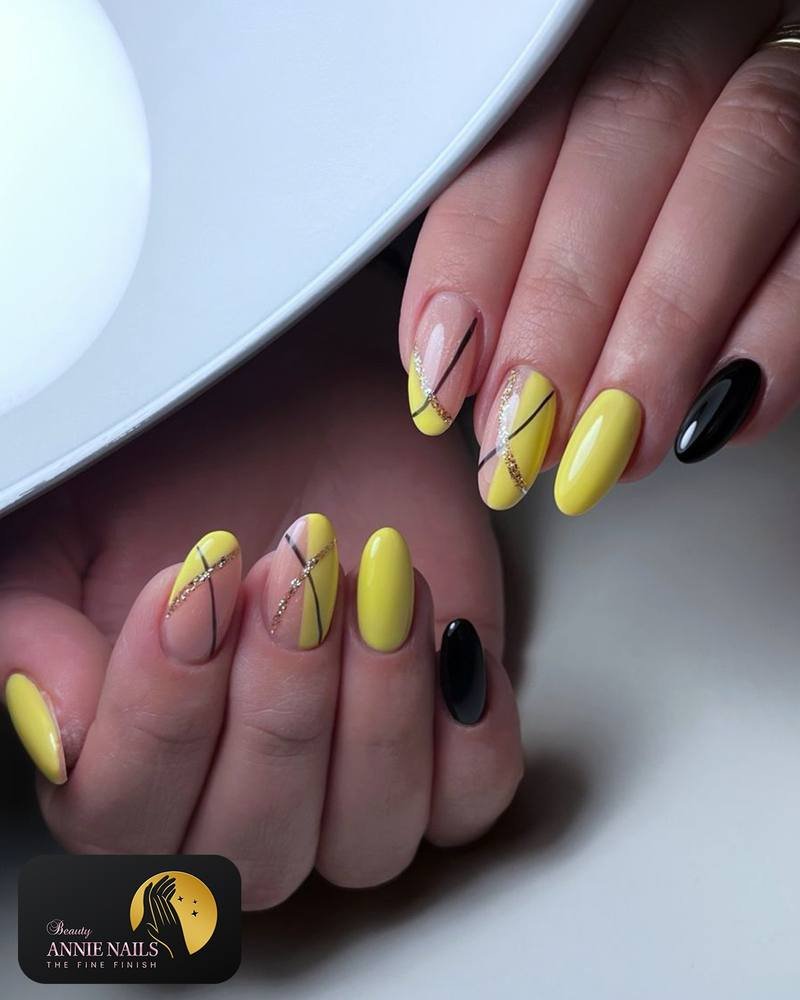 Soft Yellow Almond Nails with Black Accent Nail