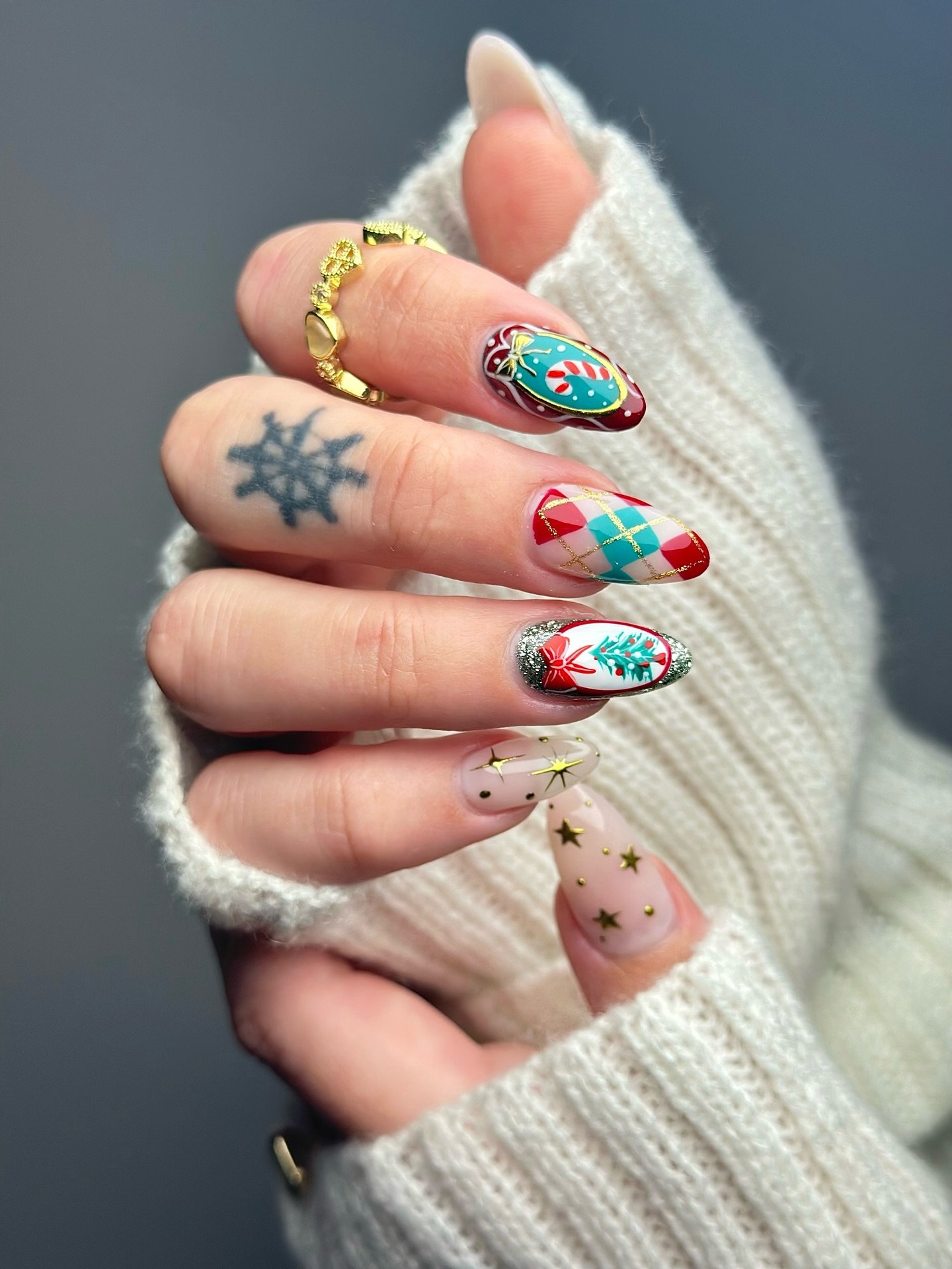 Pale Nude Festive Nails with Red, Green, and White Details