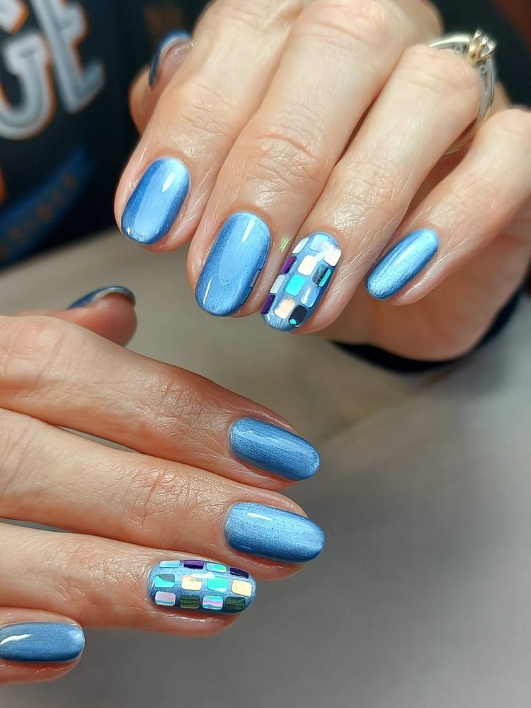 Bright blue nails with reflective mosaic accent