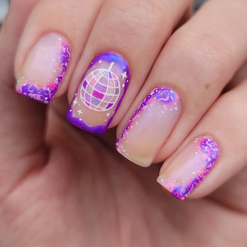 Sheer pink nails with purple glitter accents