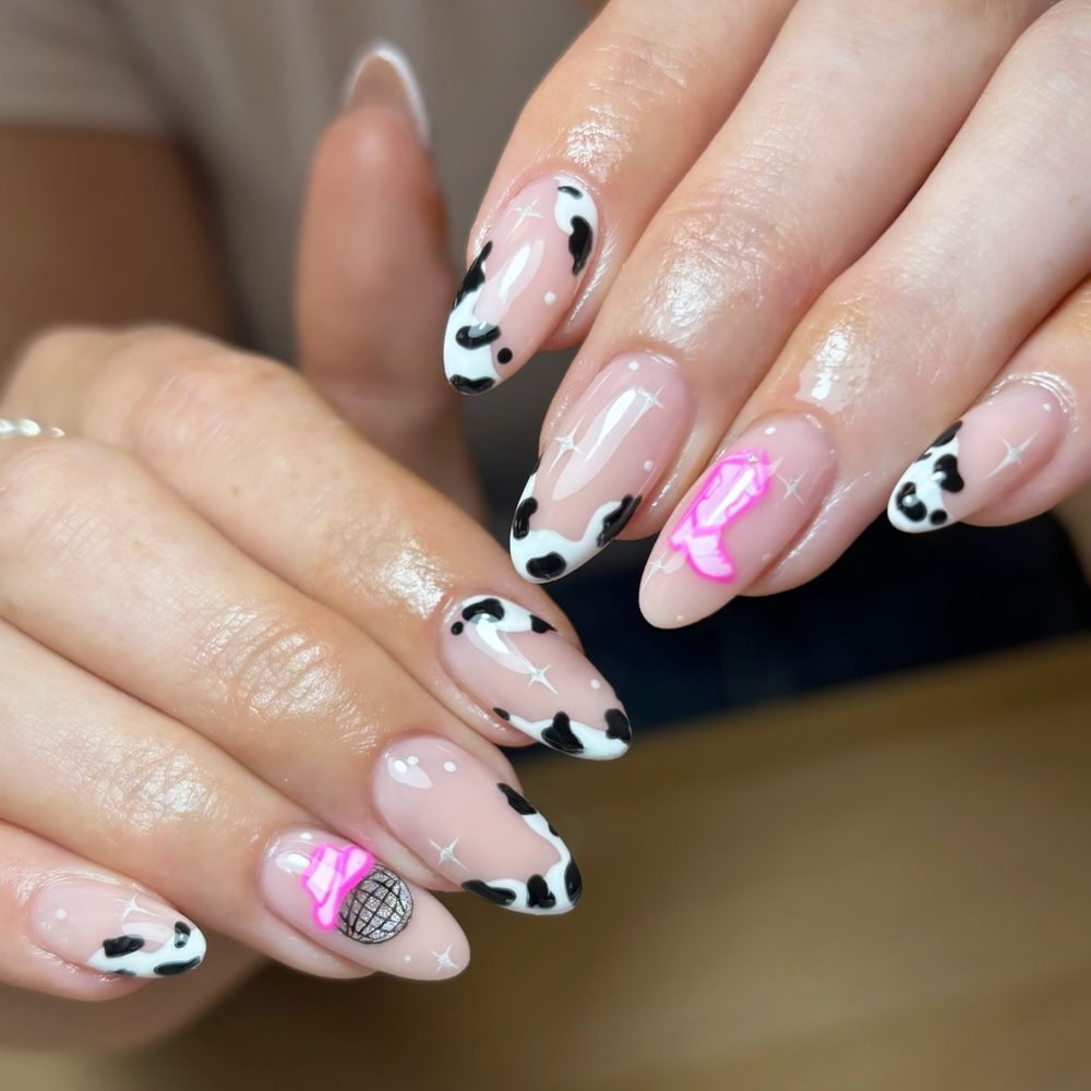 Pink white and black cow print nails with disco accent