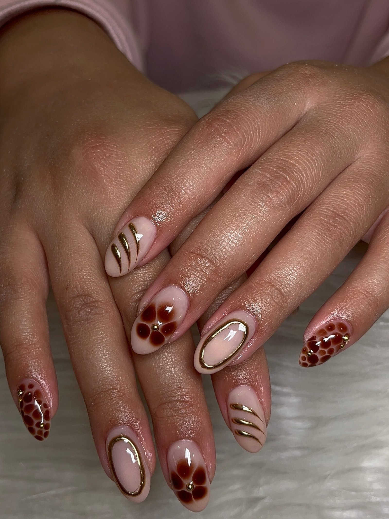 Soft Nude Nails with Burgundy and Brown Floral Accents