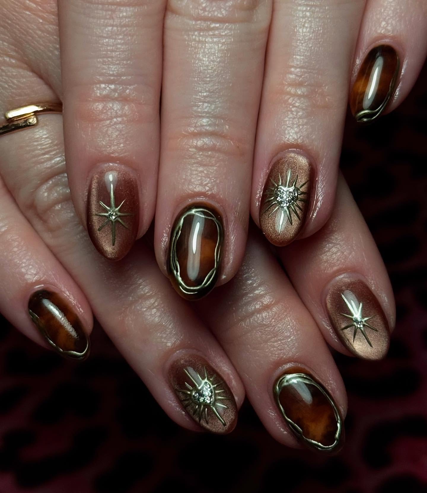 Dark Metallic Nails with Starburst Accents