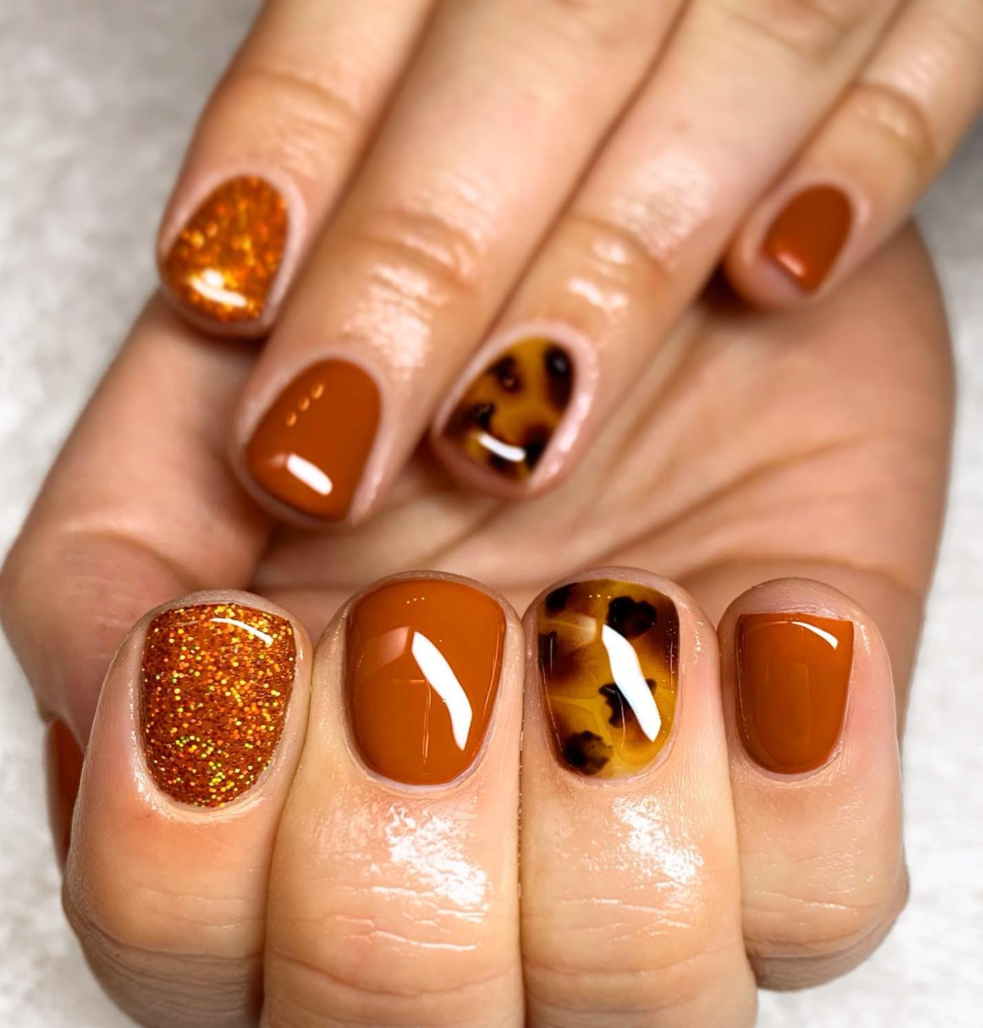 Burnt Orange Short Nails with Leopard Print Accents