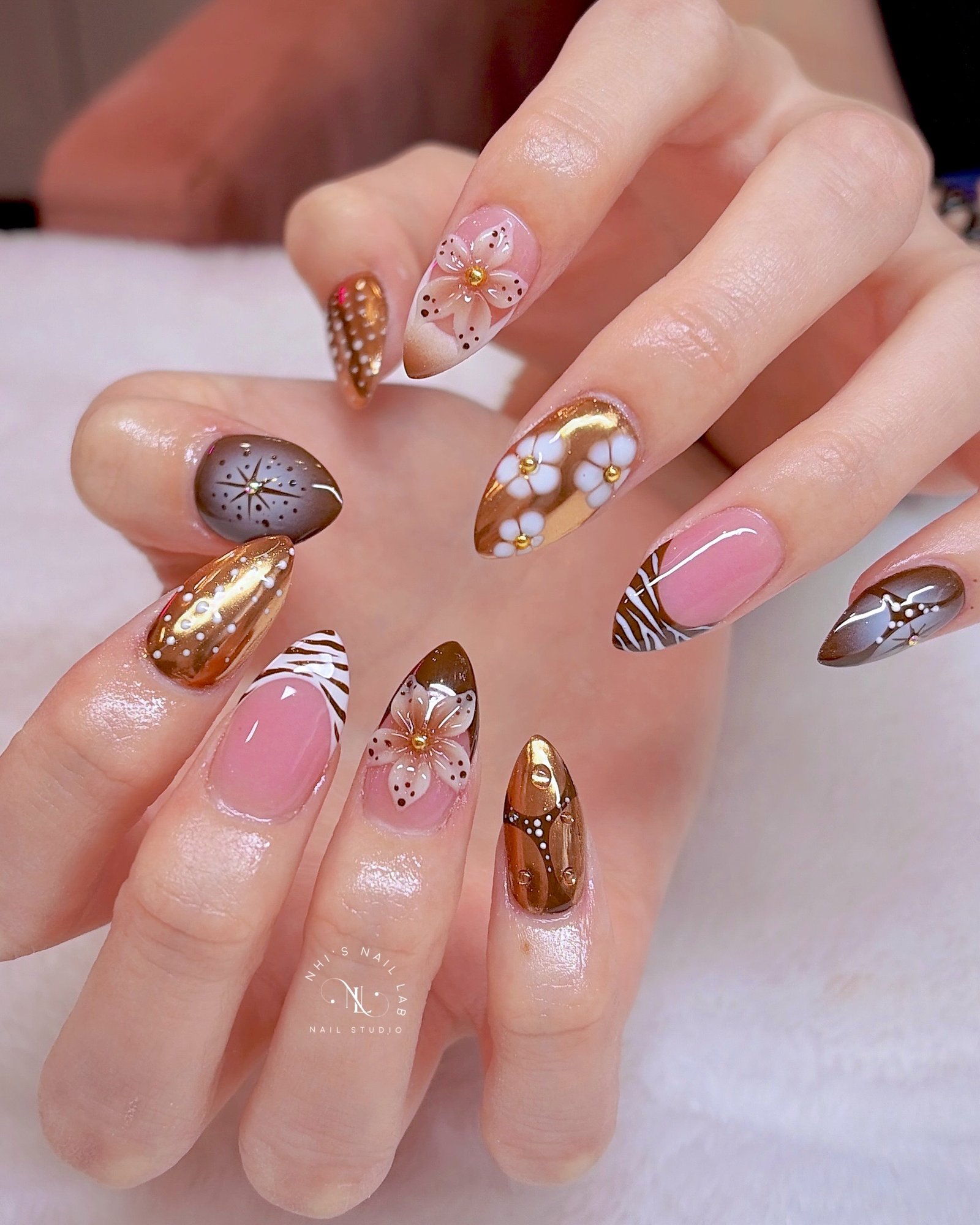 Pink Almond Nails with Gold and Floral Embellishments