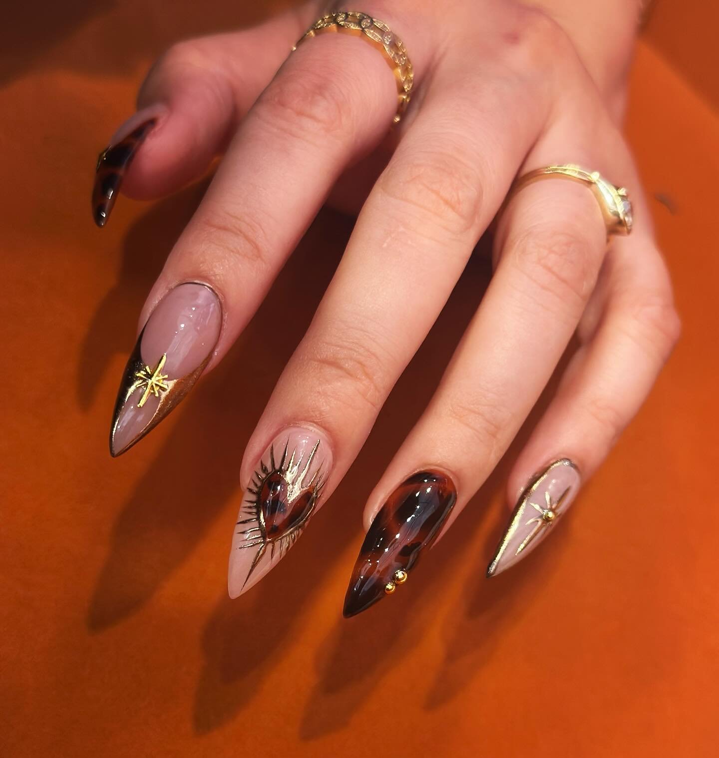 Neutral and Brown Almond Nails with Metallic Details