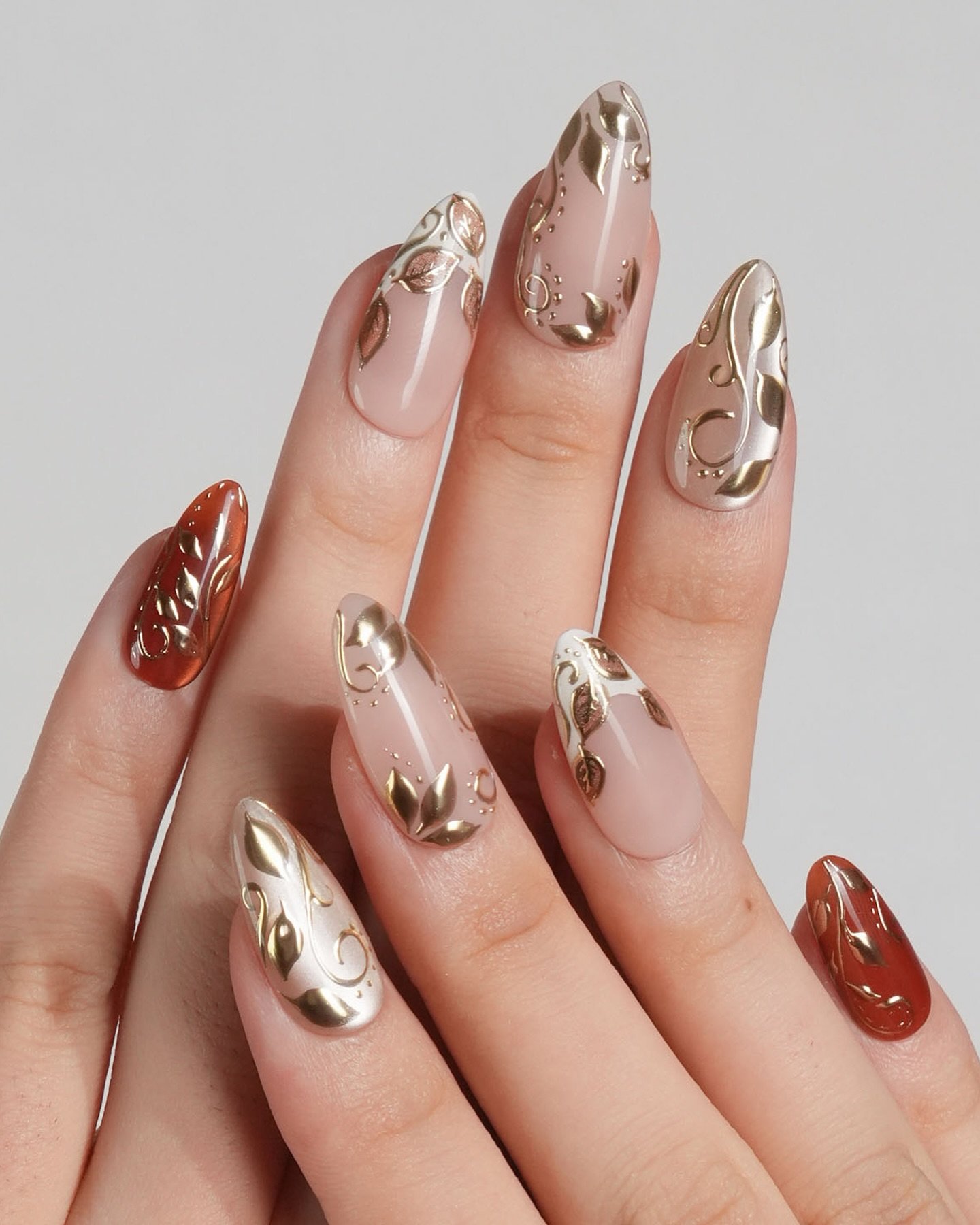 Nude Almond Nails with Gold Metallic and Brown Details