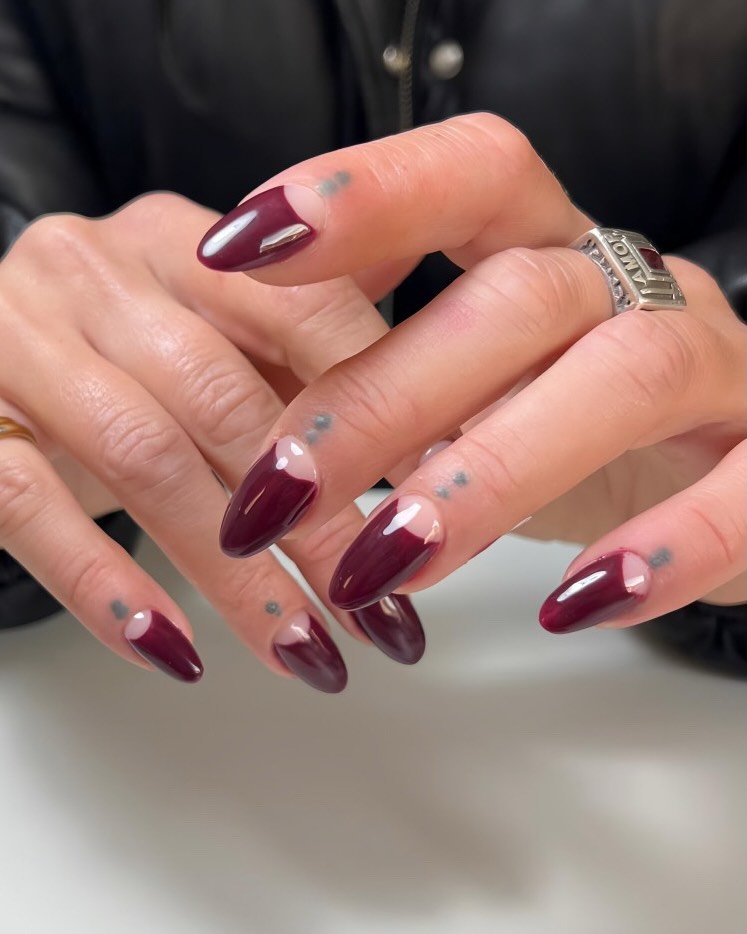 Deep Burgundy Stiletto Nails with Nude Half-Moon Spaces