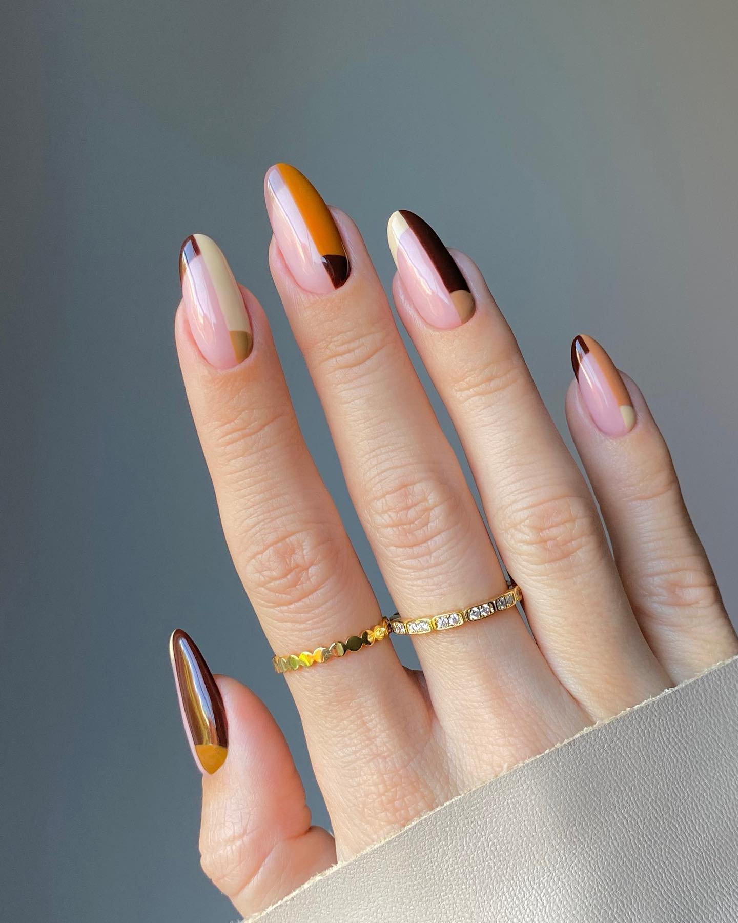 Soft Pink Almond Nails with Orange and Brown Half-Moon Details