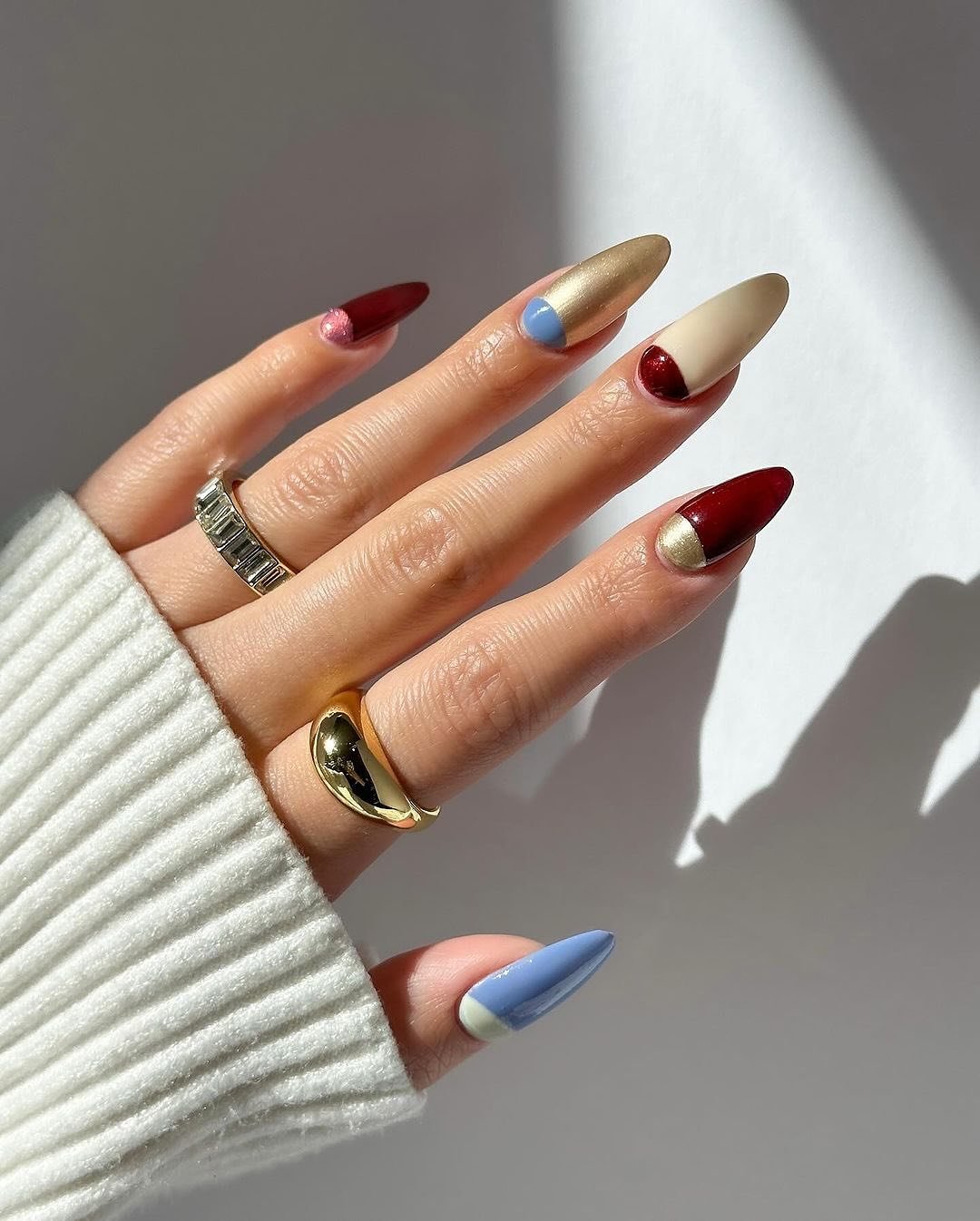 Mixed Neutral Nails with Red and Blue Half-Moon Accents