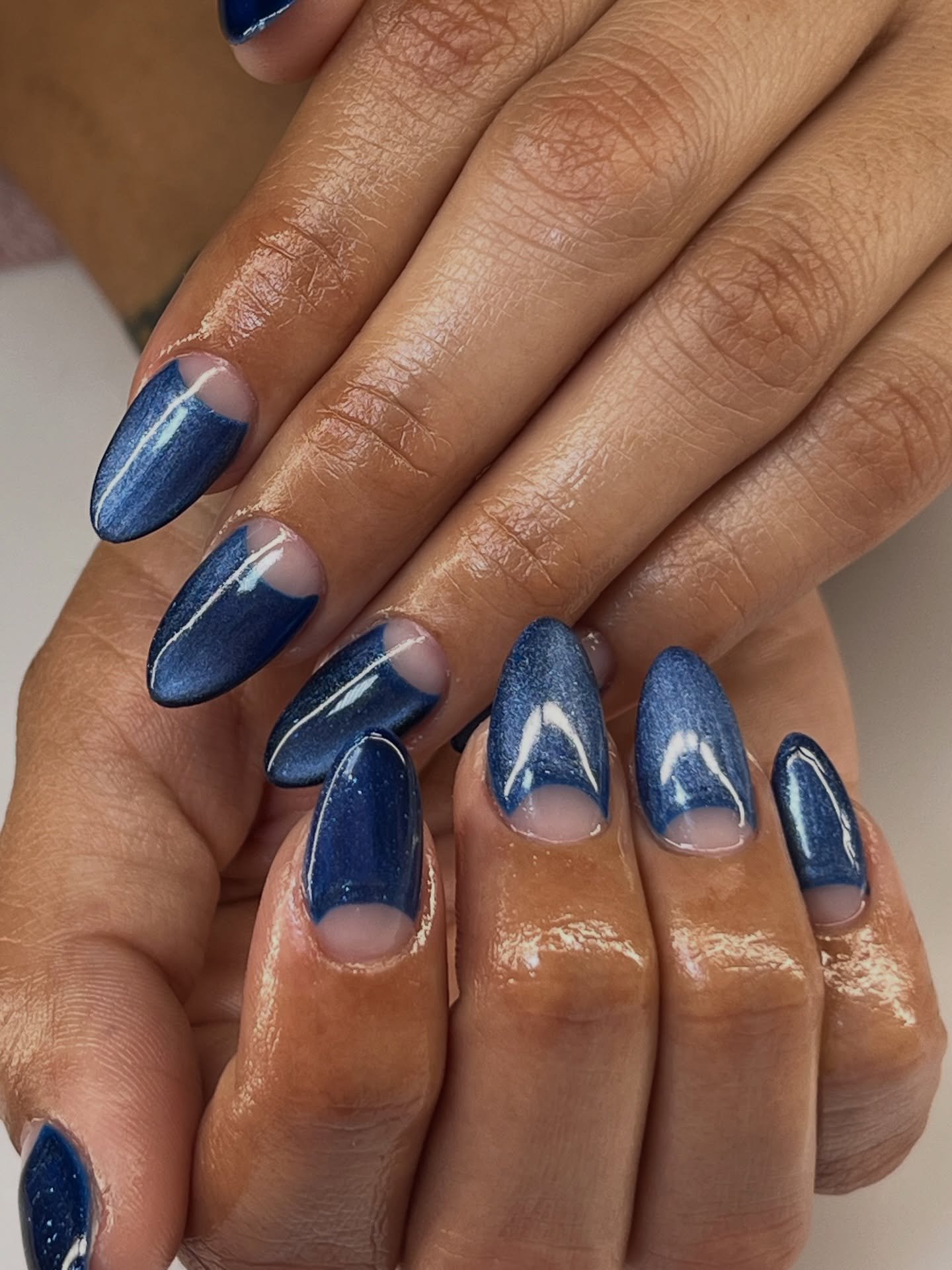 Shimmering Blue Almond Nails with White Half-Moons