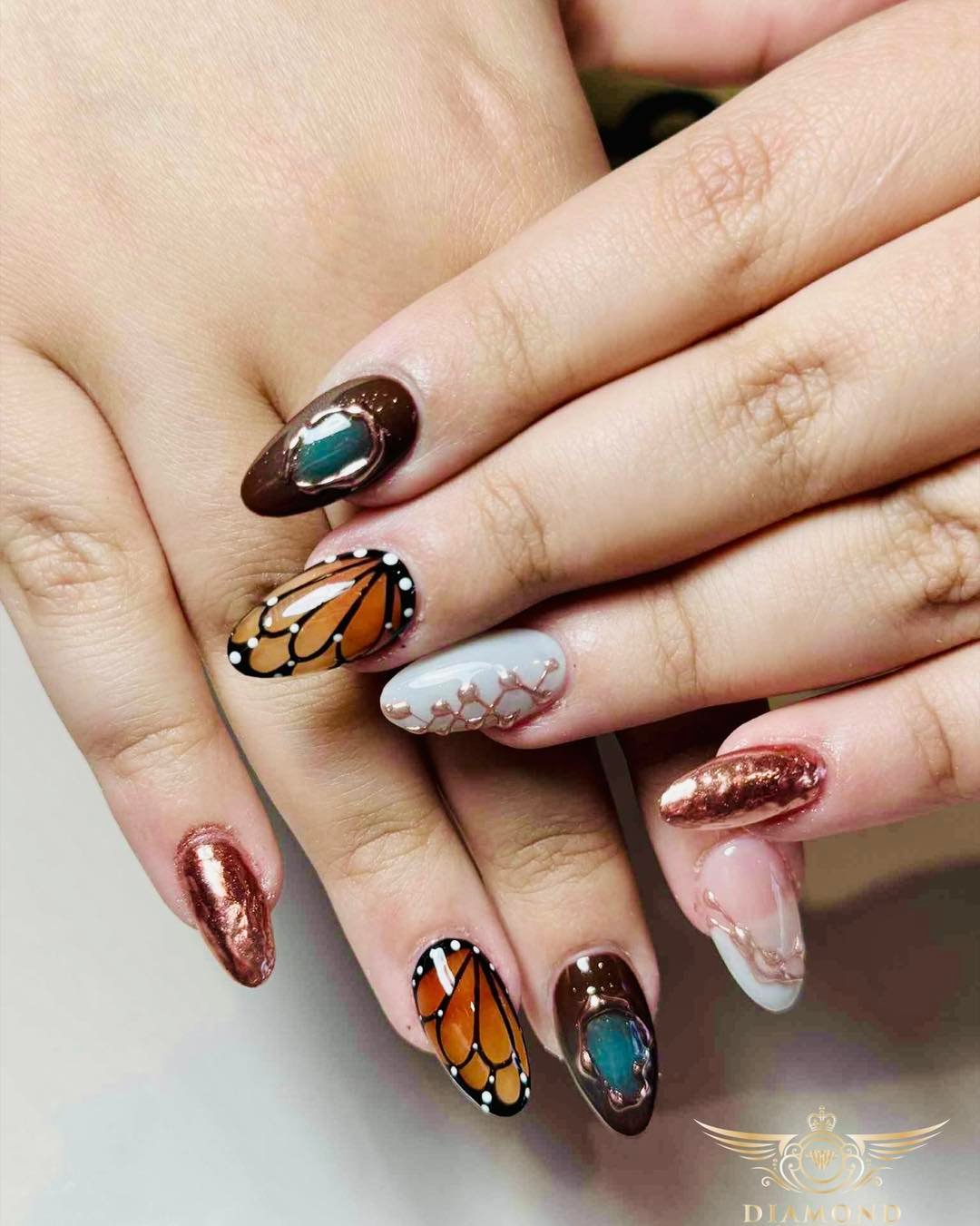 Brown Chrome Nails with Gold and Silver Accent Art