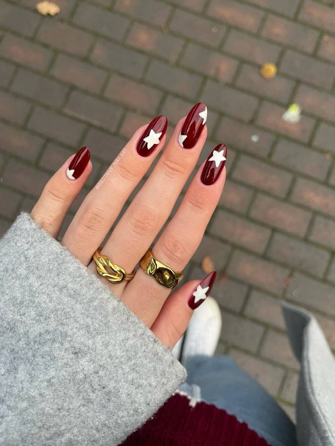 Burgundy Nails with White Star Accents