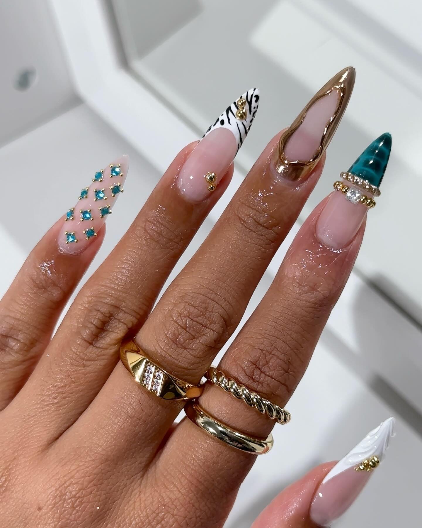 Pink Almond Nails with Teal, Brown, and Gold Accents