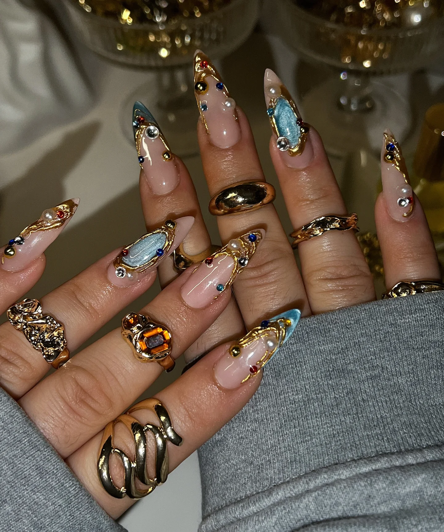Long Almond Nails with Mixed Warm Tones and Gold Accents