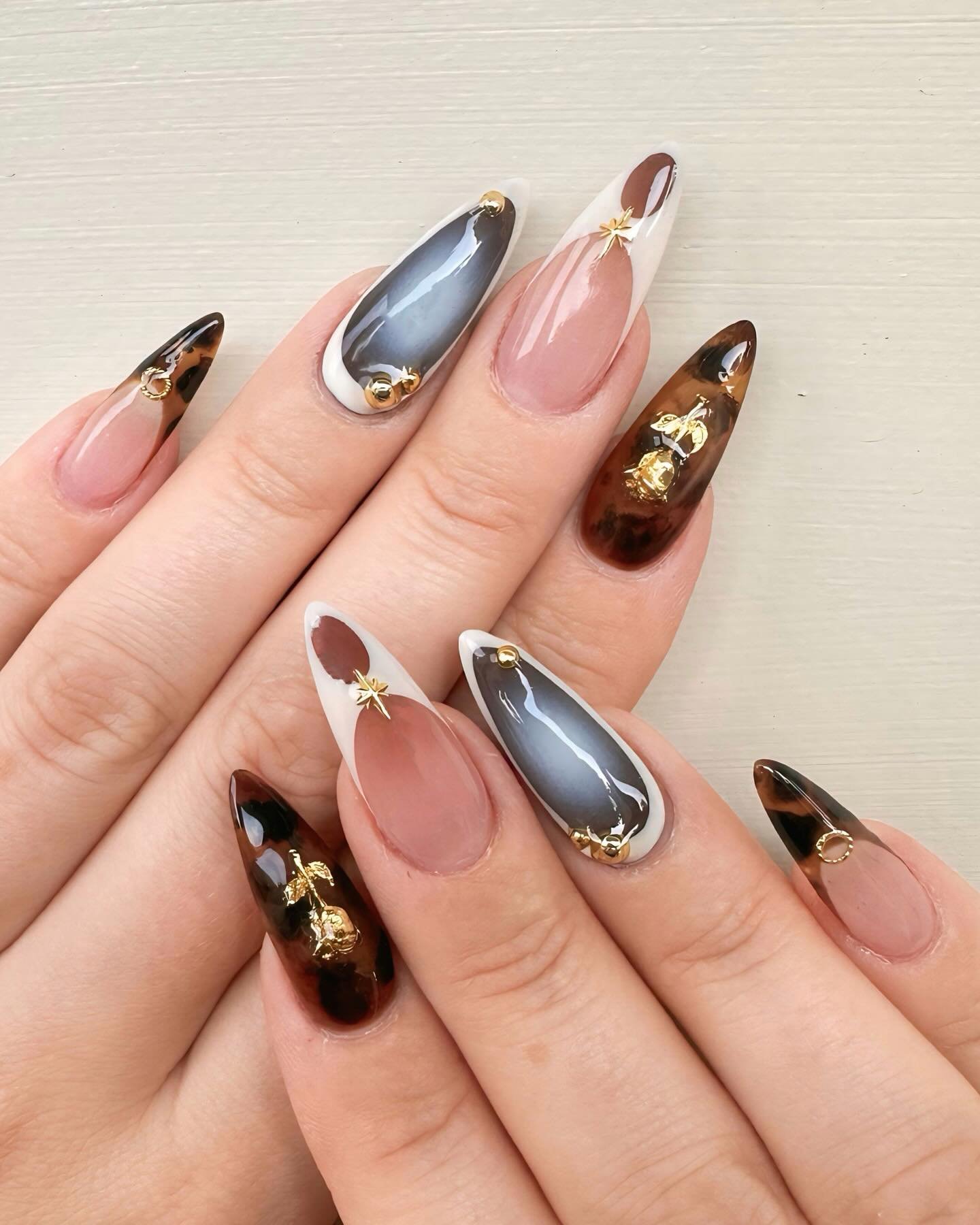 Nude Almond Nails with Black, Silver, and Gold Abstract Accents
