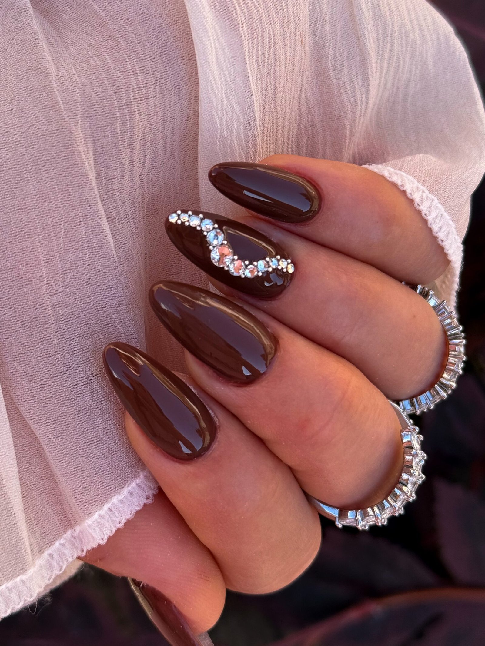 Deep Brown Almond Nails with Glittering Accent Details