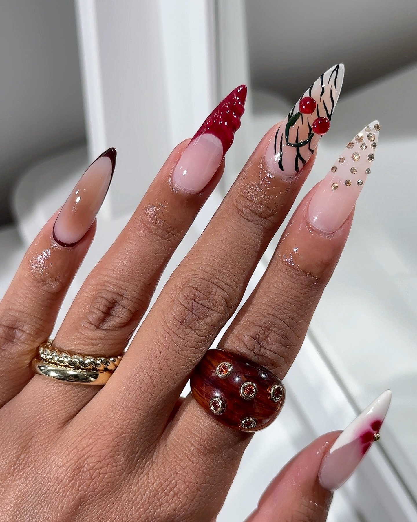 Nude Almond Nails with Red, Brown, and Leopard-Style Accents