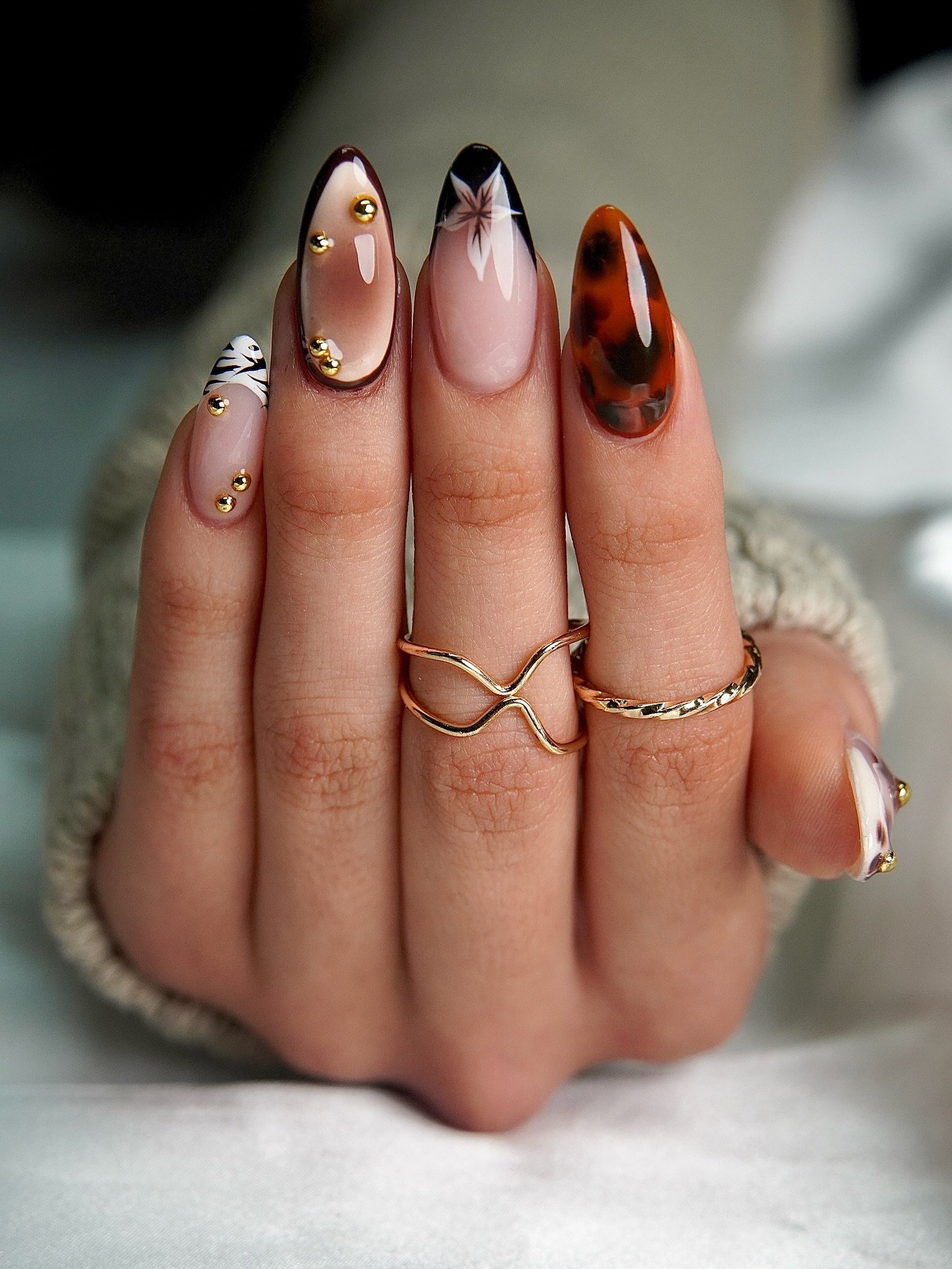 Nude Almond Nails with Brown and Black Animal-Print Accents