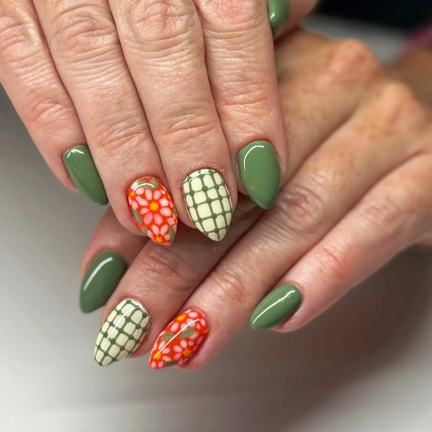 Green Nails with Gingham and Bright Orange Floral Accents