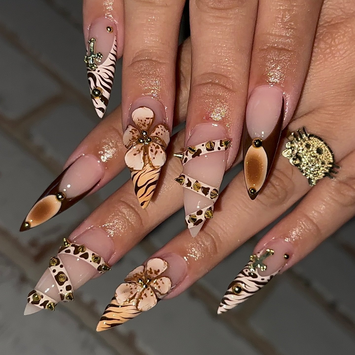 Nude Stiletto Nails with Brown and Gold Patterned Accents