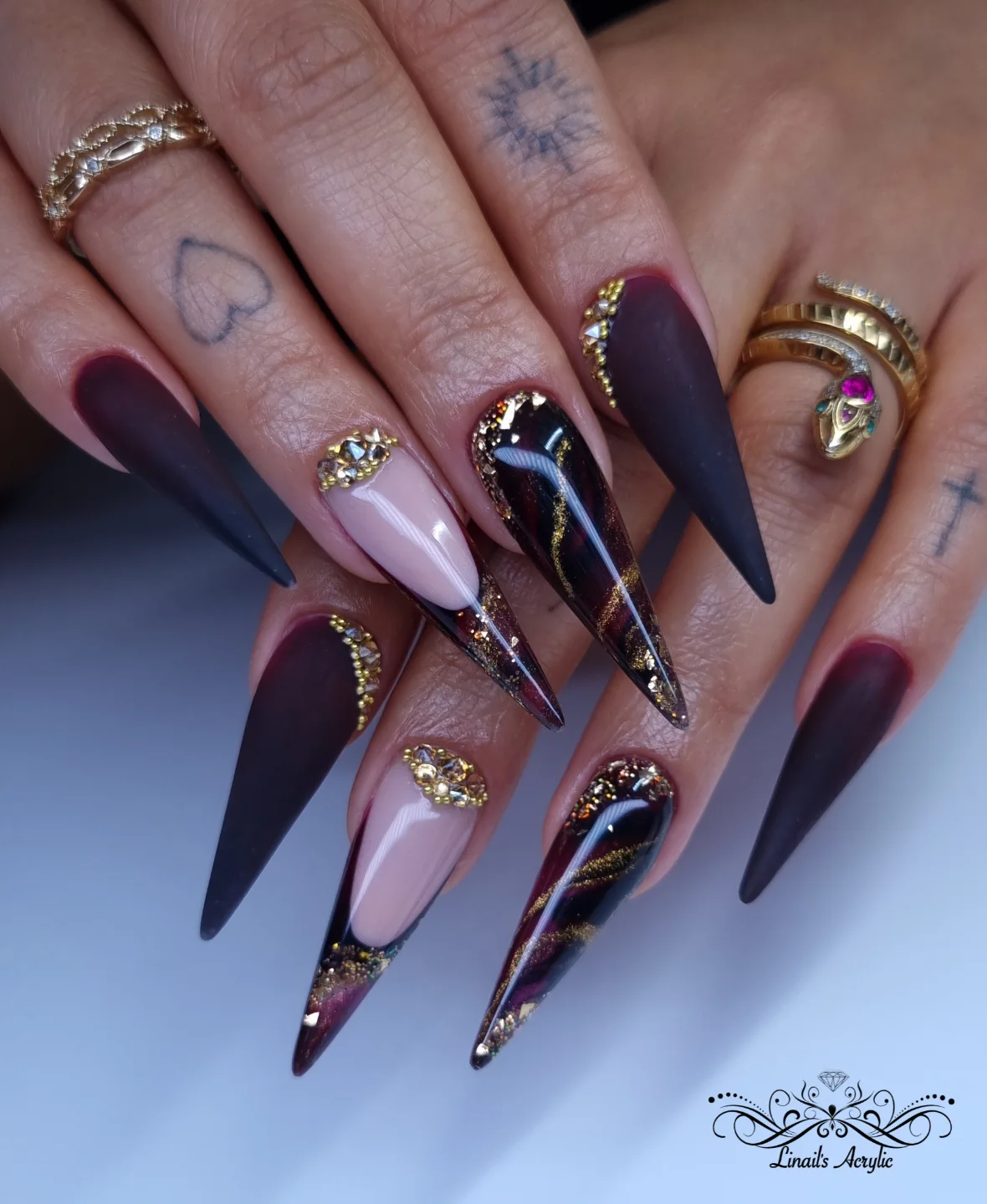 Purple, Pink, and Black Stiletto Nails with Gold Accents