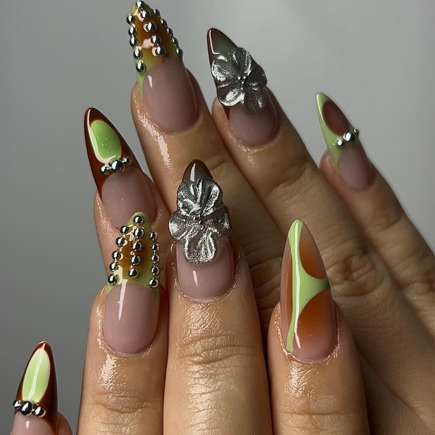 Olive and Nude Stiletto Nails with 3D Floral Accents