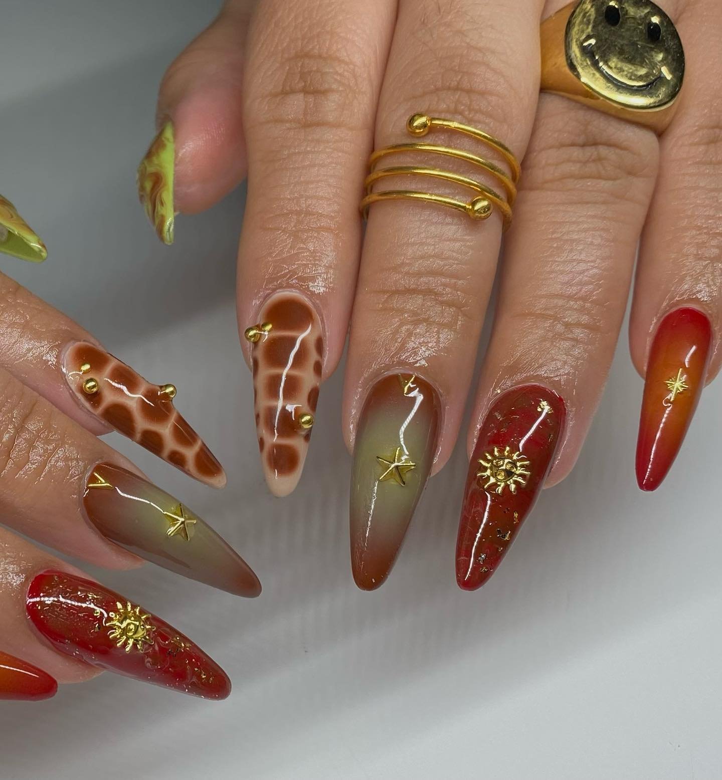 Brown, Red, and Gold Stiletto Nails with Autumn Details