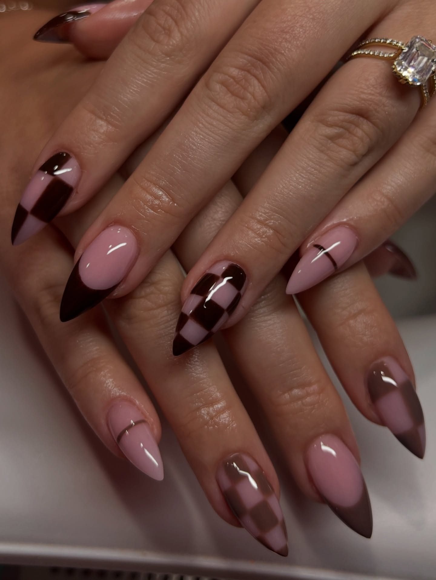 Pink Almond Nails with Deep Brown Tips and Geometric Accents